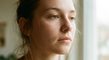 Young woman with a healed septum piercing wearing a minimalist titanium clicker ring