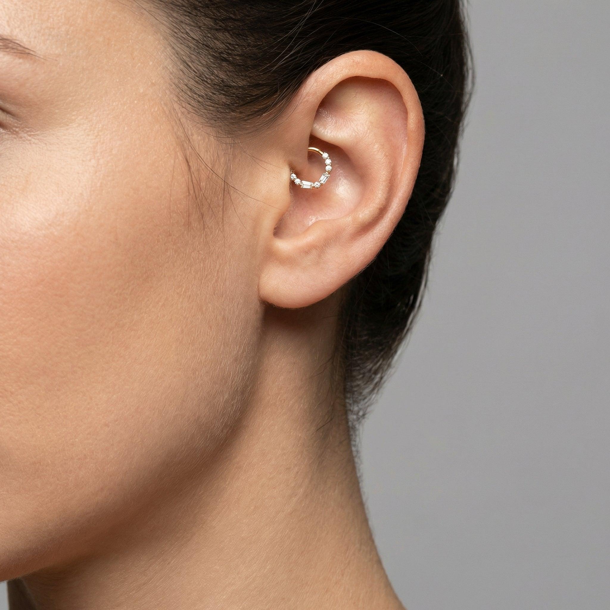 Profile view of a model wearing a silver baguette and round zircon