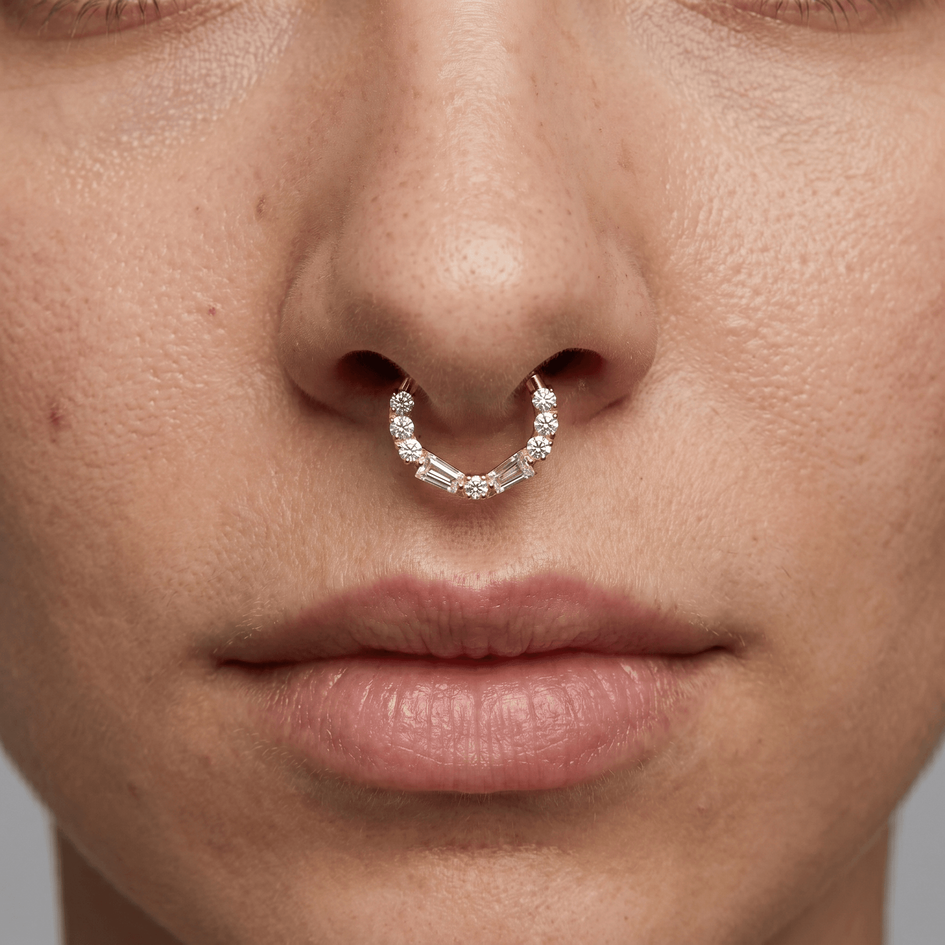 Model showcasing a silver baguette and round zircon hinged clicker ring styled