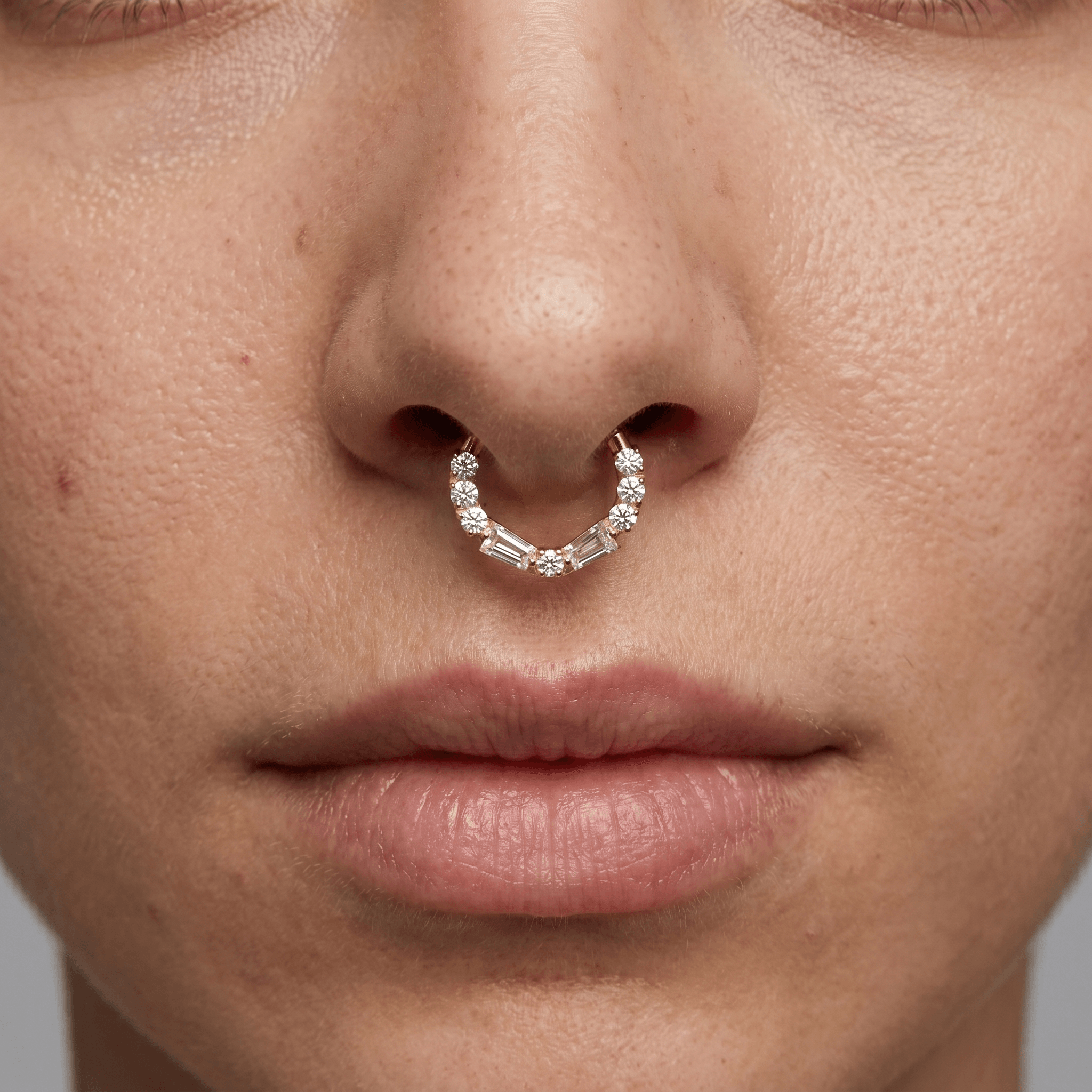 Model showcasing a silver baguette and round zircon hinged clicker ring styled