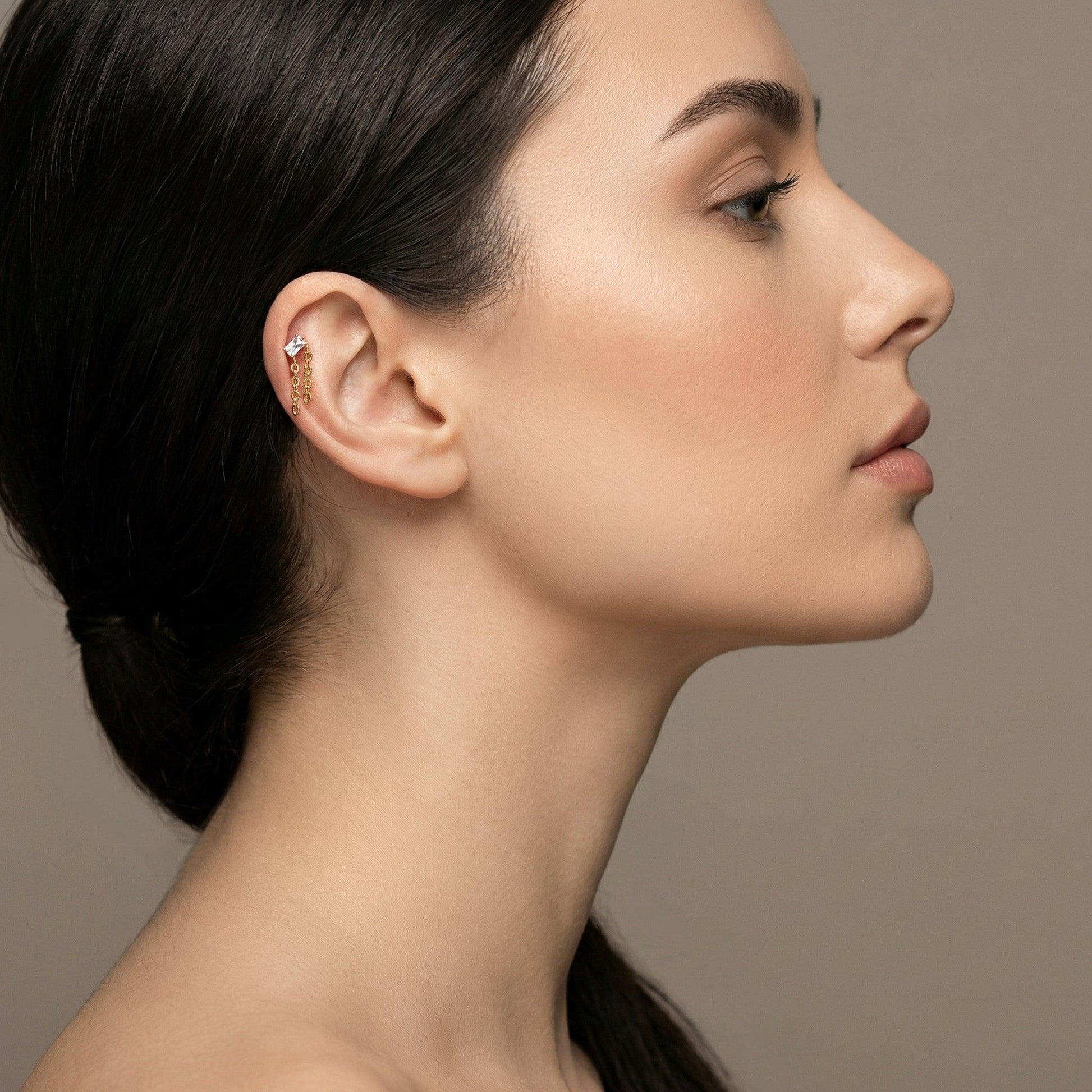 Profile view of a female model wearing a silver titanium baguette zircon