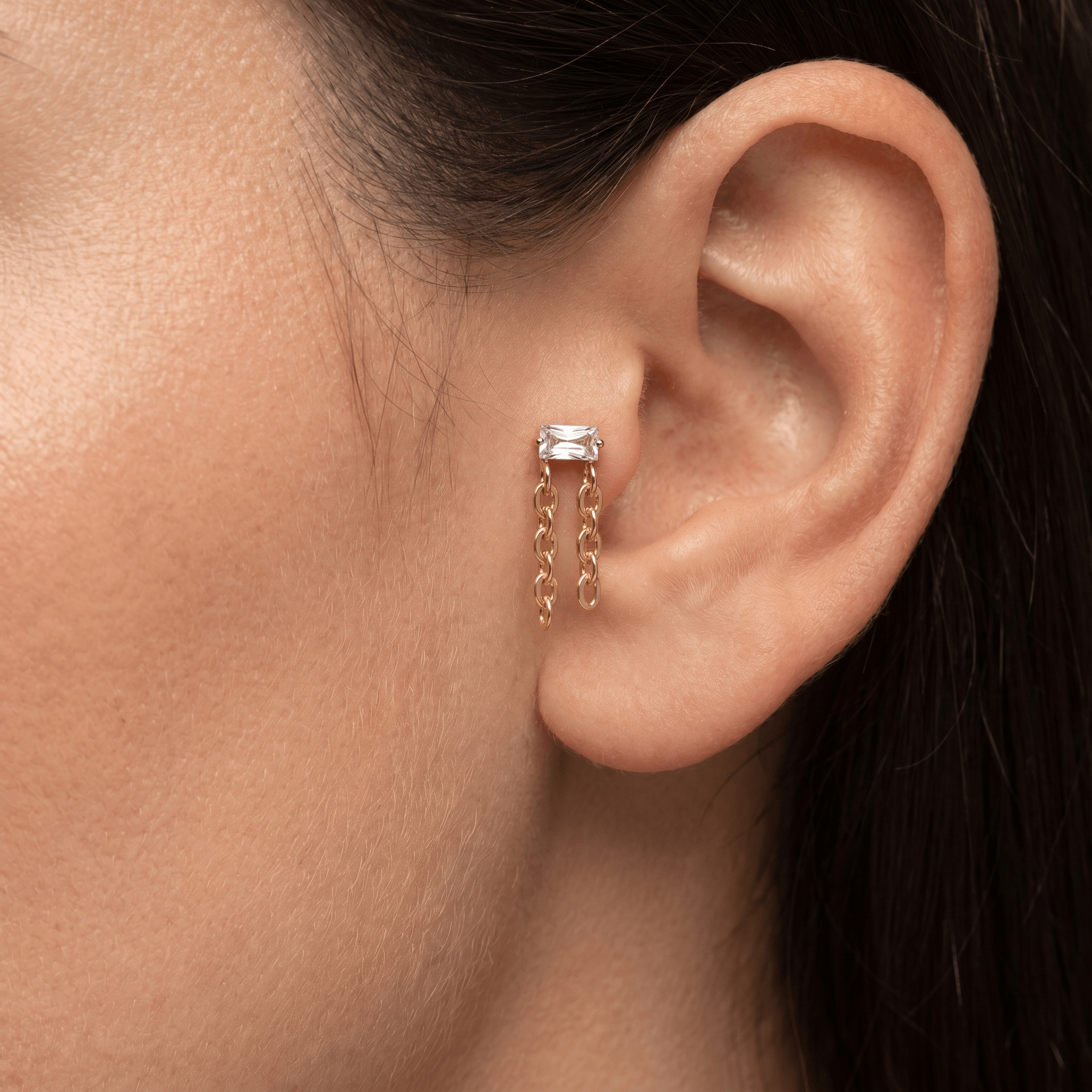 Gold titanium baguette zircon chain piercing stud worn elegantly in a female