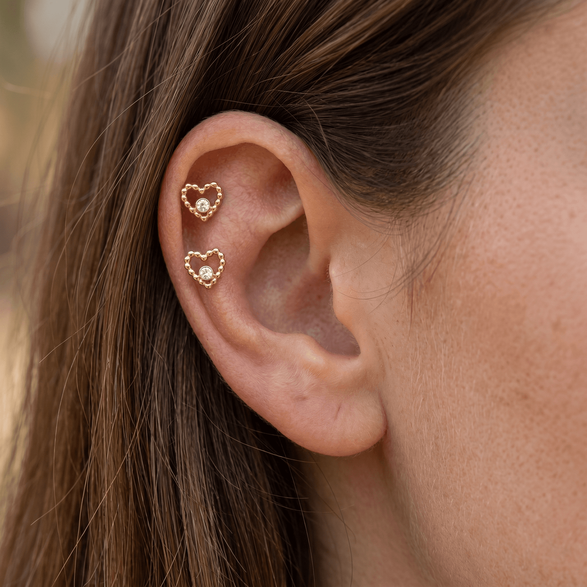 Gold beaded heart cz stud — double helix piercing placement
