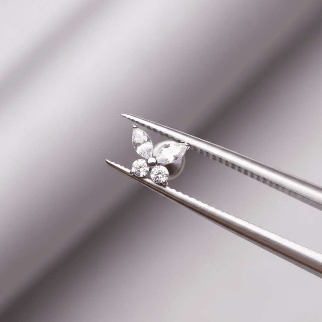 Cz Forward Helix Piercing - Tweezers holding a delicate