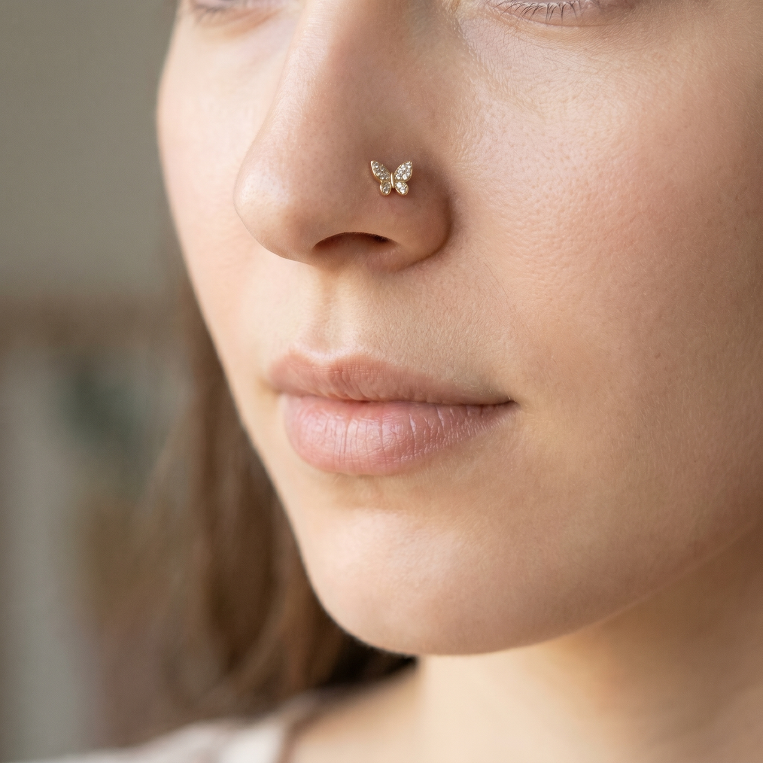 butterfly nose stud close-up on a model — single nostril nose jewelry