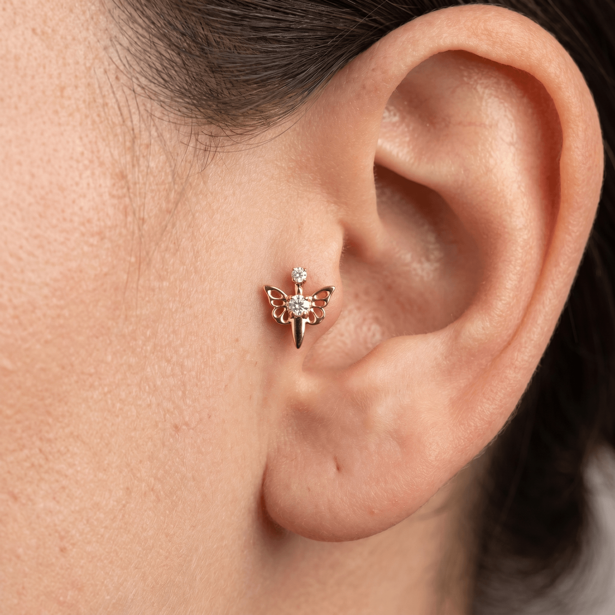 Gold butterfly zircon stud — tragus jewelry placement