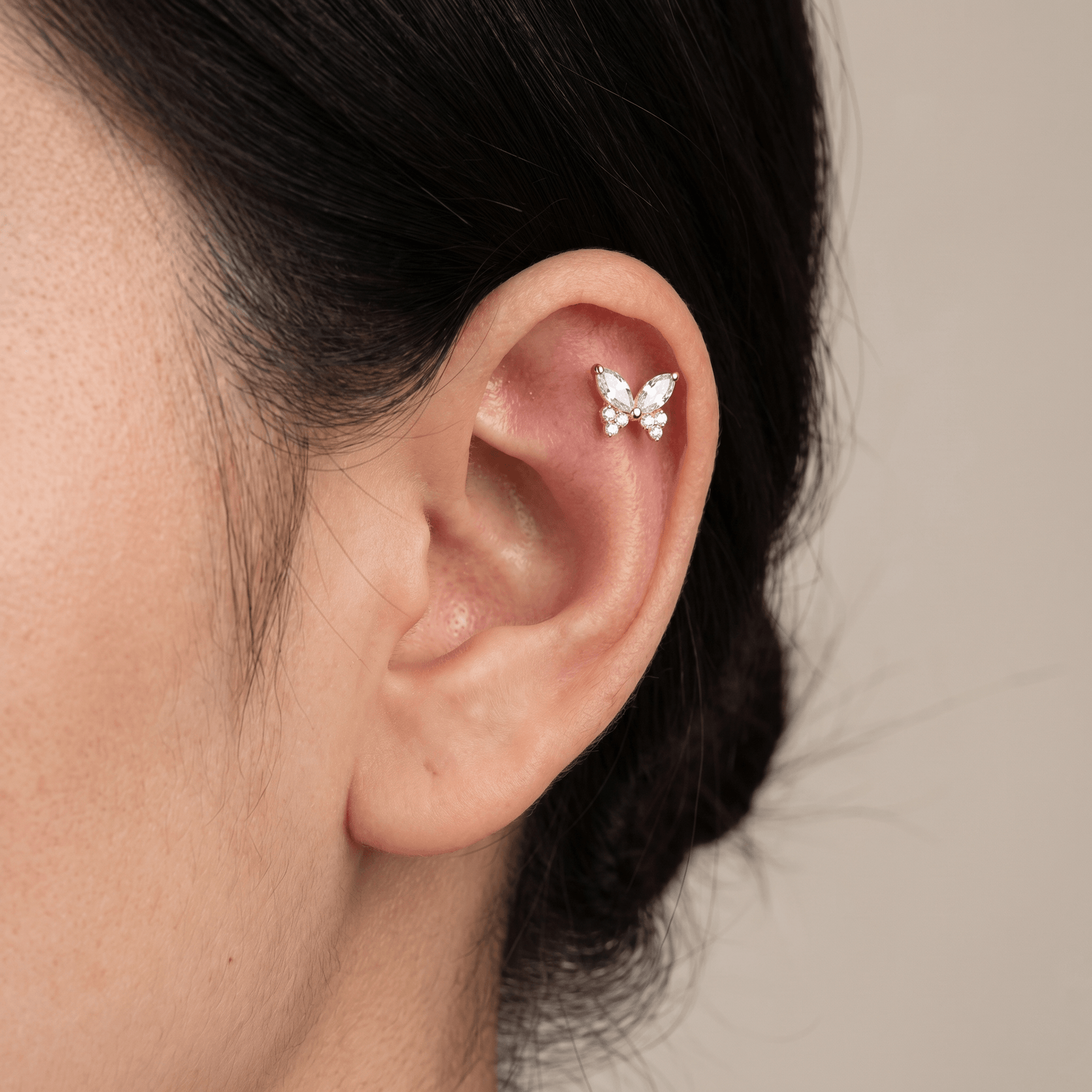Gold butterfly zircon stud — flat helix piercing placement