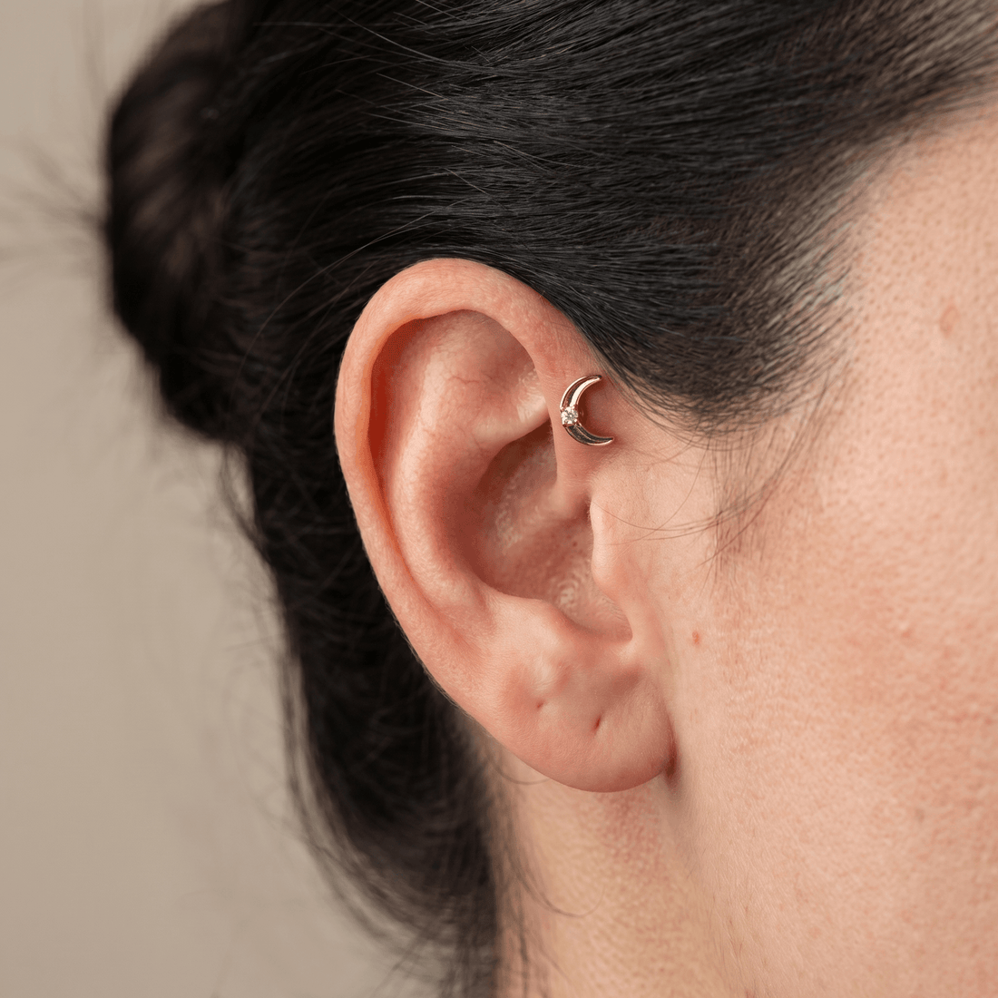 Gold crescent moon zircon stud — forward helix piercing placement
