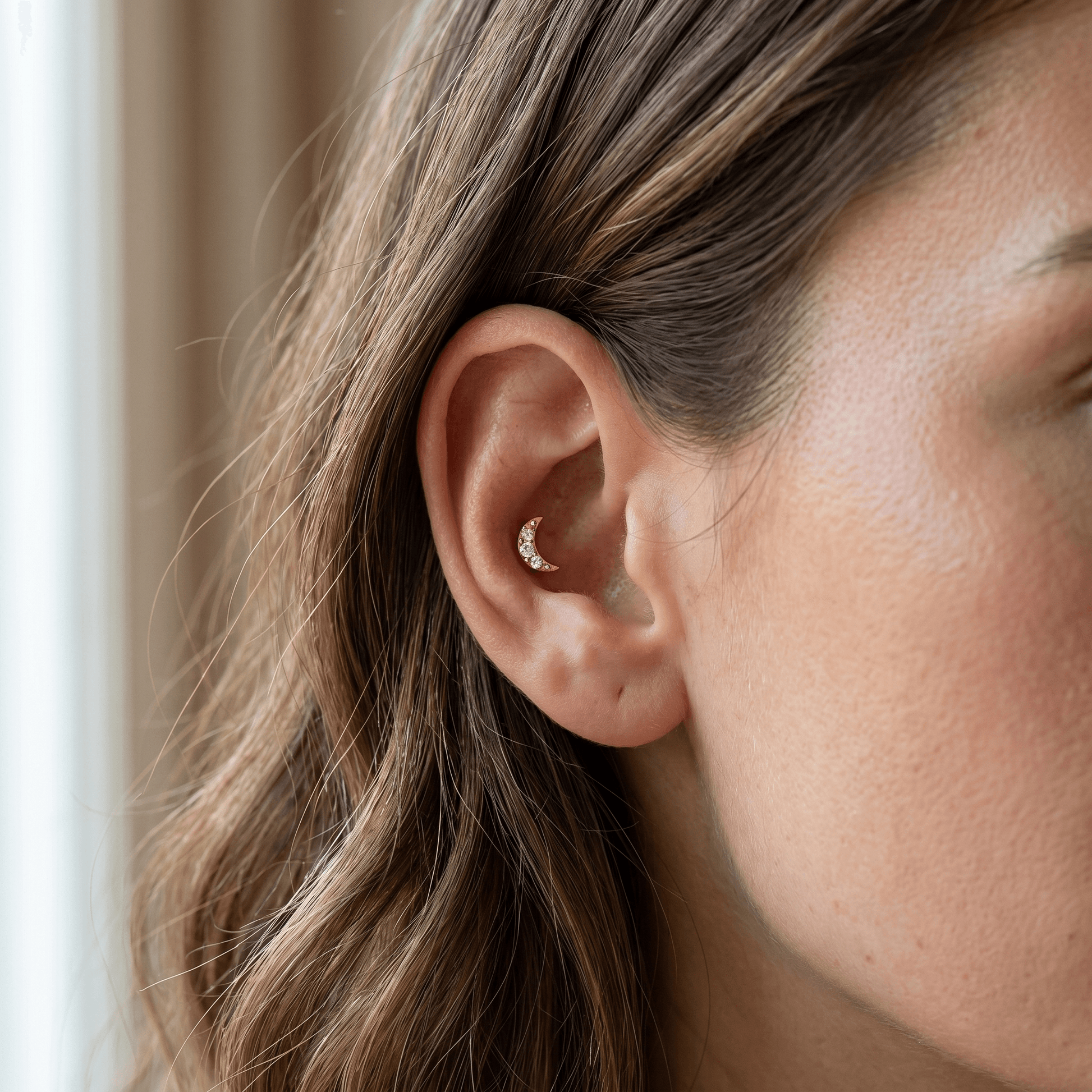 Gold titanium crescent moon zircon piercing stud worn perfectly in a female