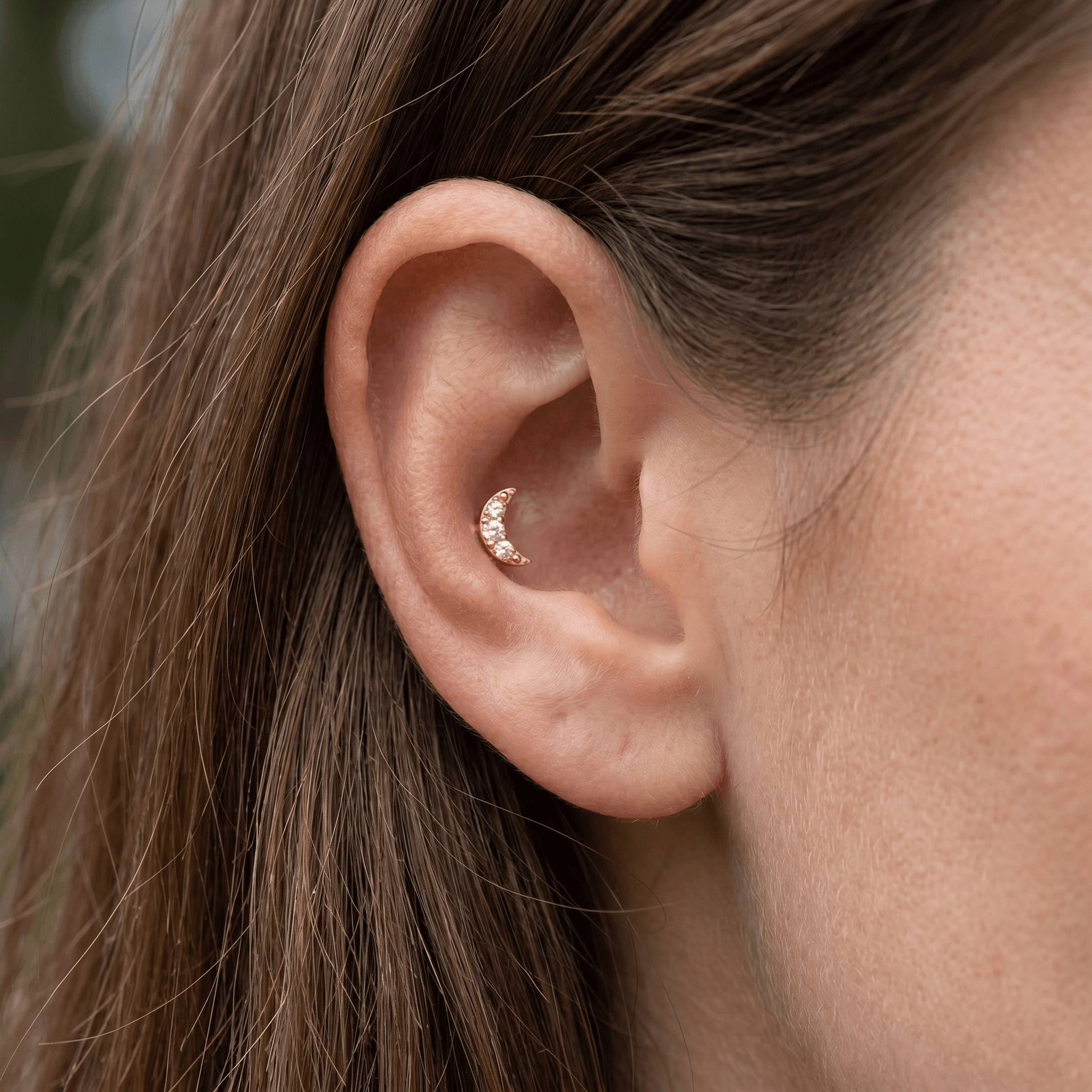 Gold titanium crescent moon zircon piercing stud worn elegantly in a female