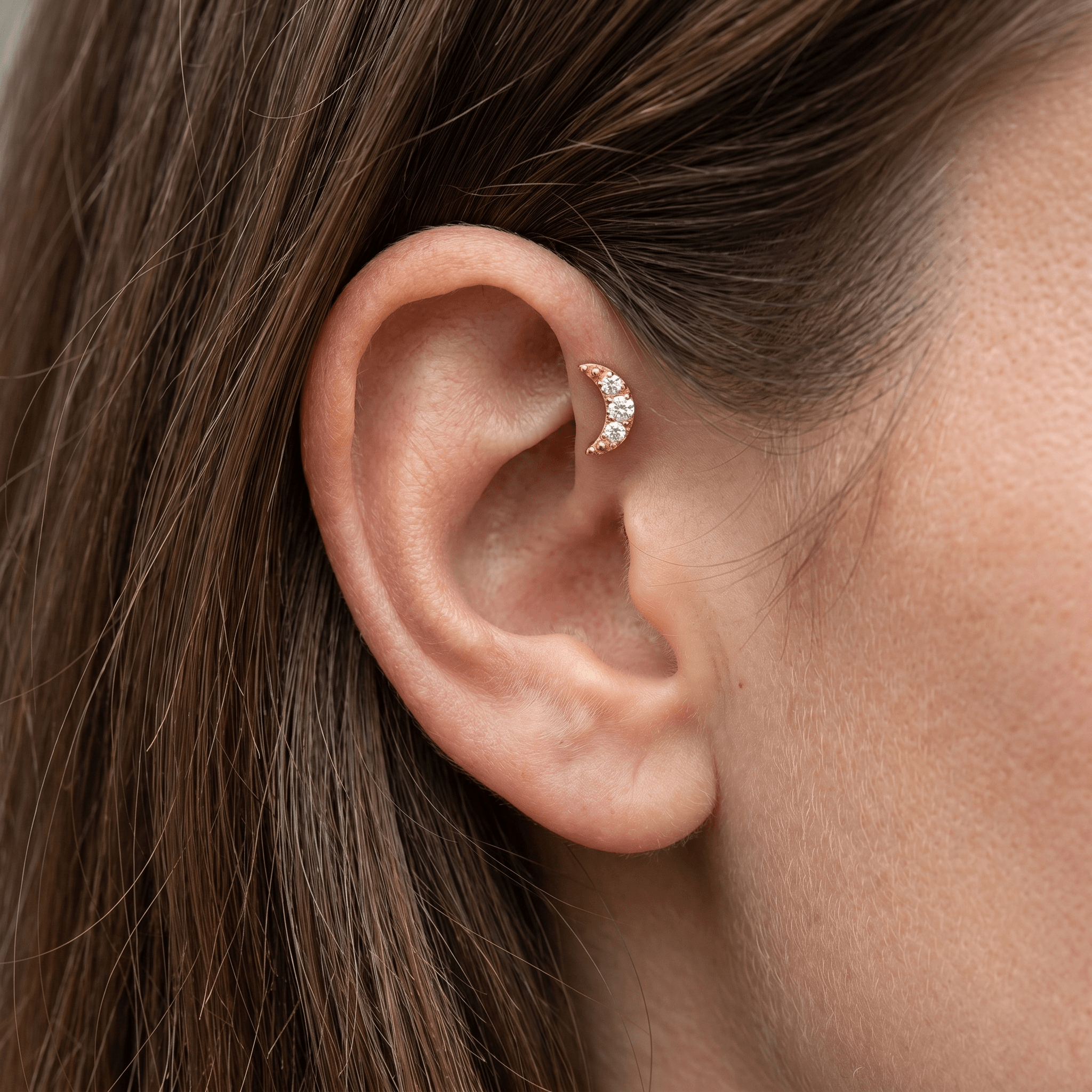 Gold titanium crescent moon zircon piercing stud worn beautifully in a female