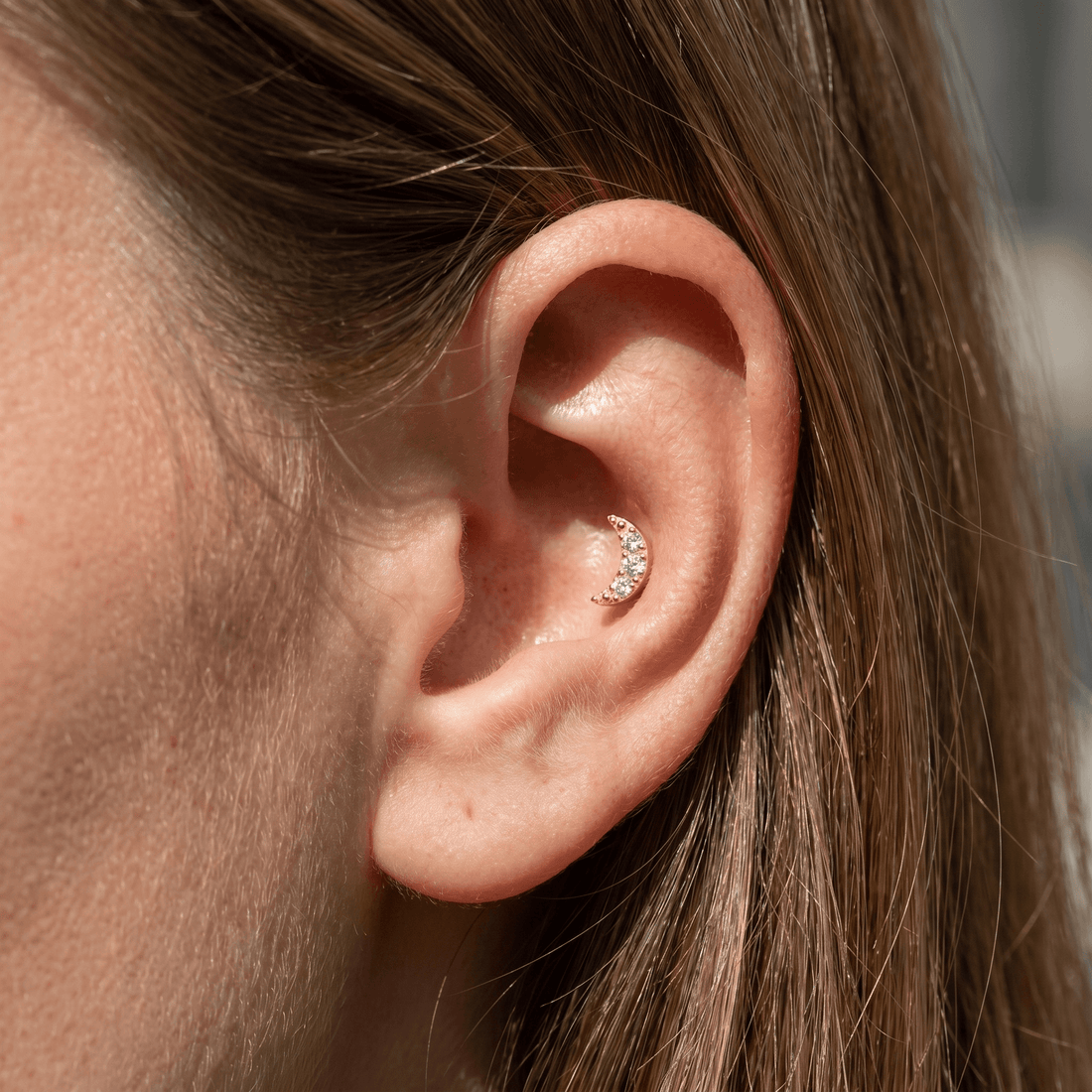 Gold crescent moon zircon stud — conch jewelry placement