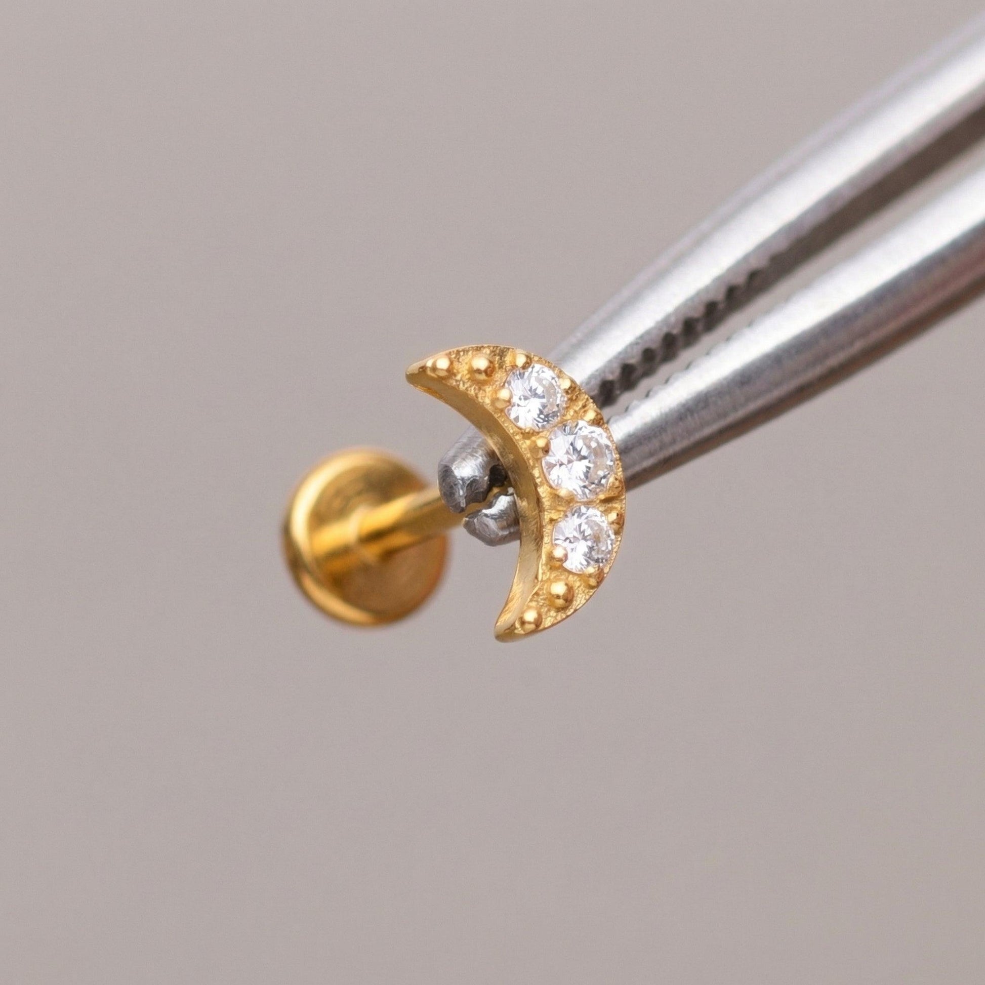 Tragus Ear Piercing Jewelry - Tweezers holding a gold