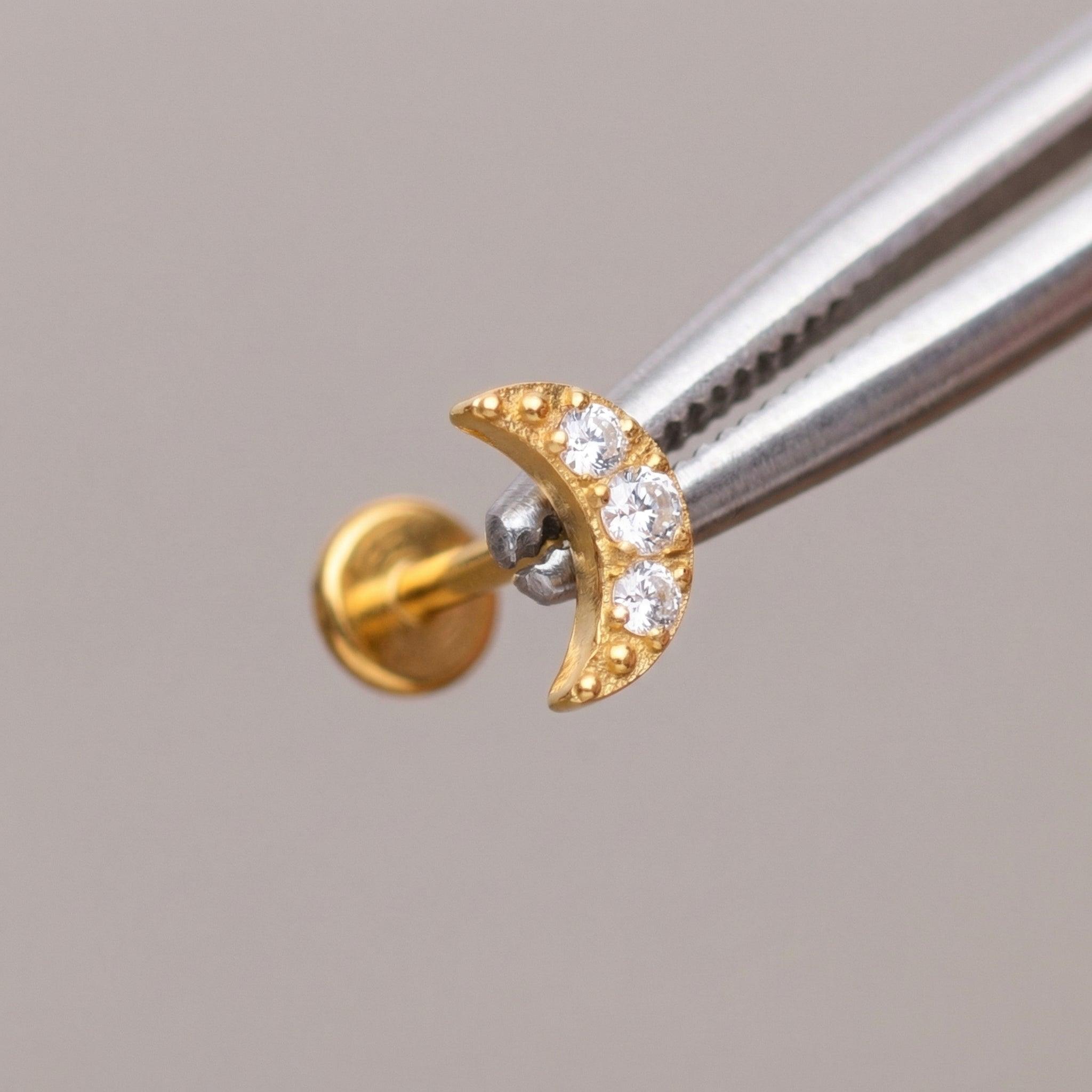 Tragus Ear Piercing Jewelry - Tweezers holding a gold