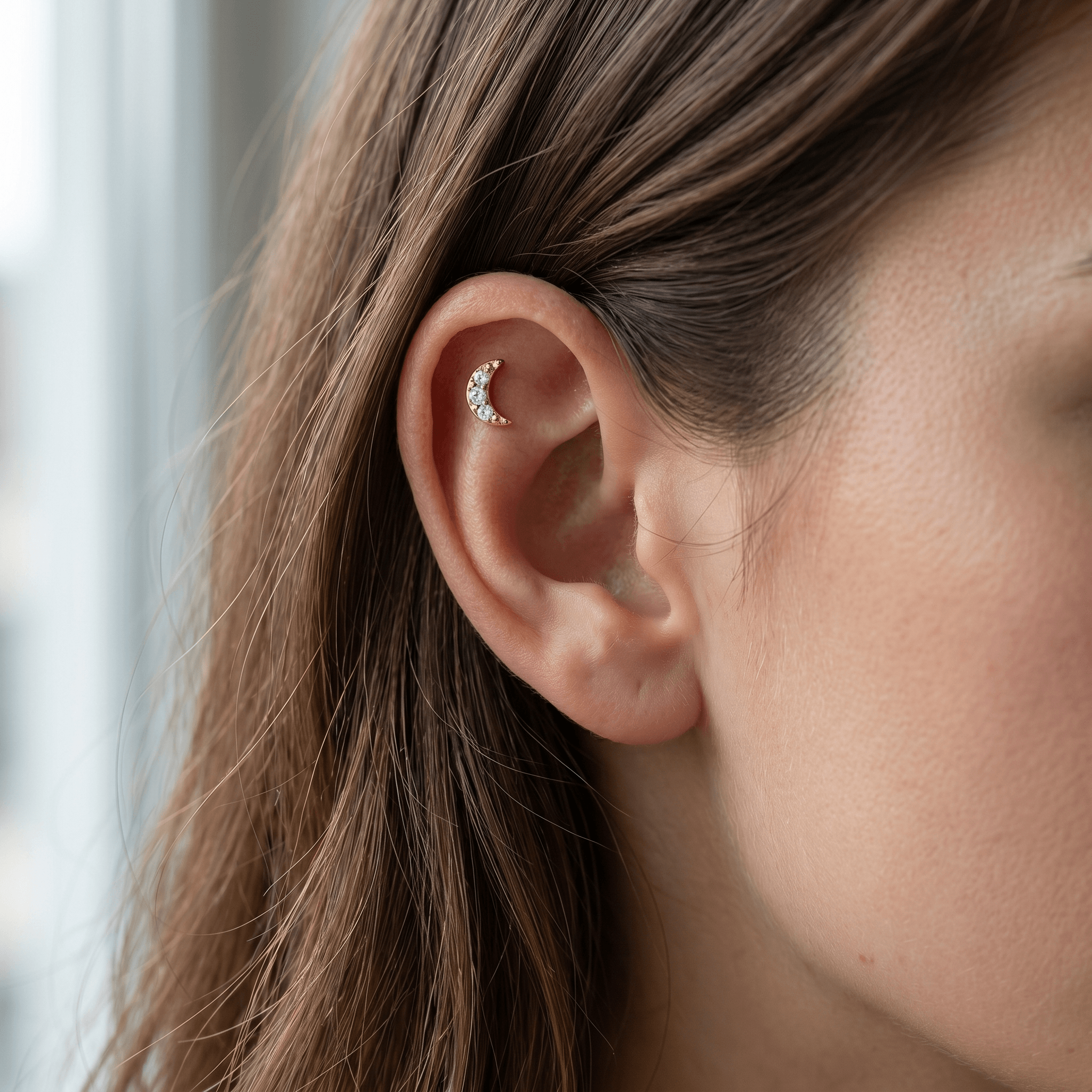 Gold titanium crescent moon zircon piercing stud worn elegantly in a female