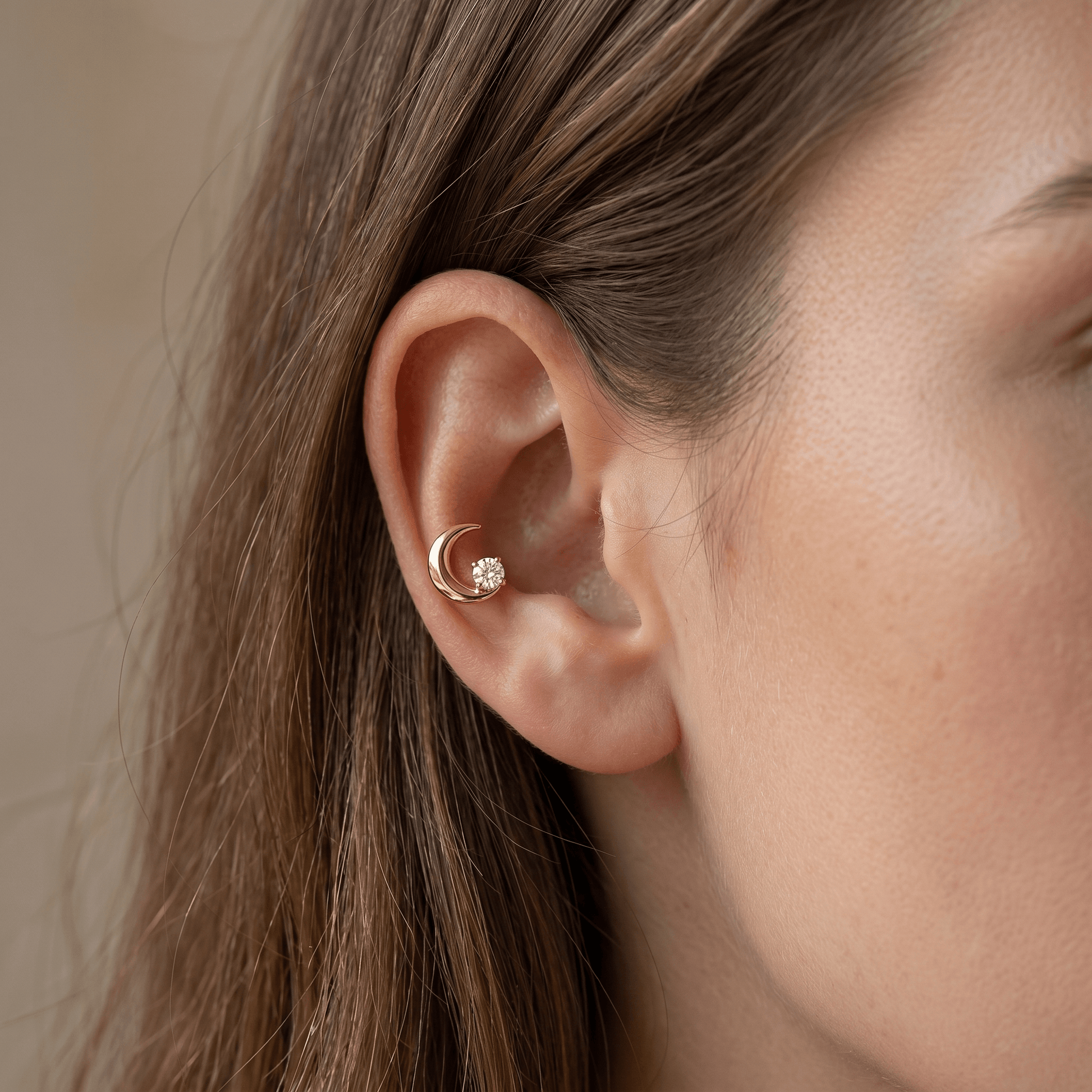 Gold celestial cartilage stud worn elegantly in a piercing.