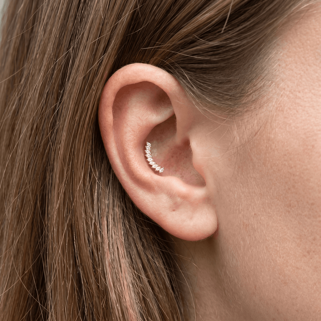 Silver crown leaf zircon stud — outer conch piercing placement