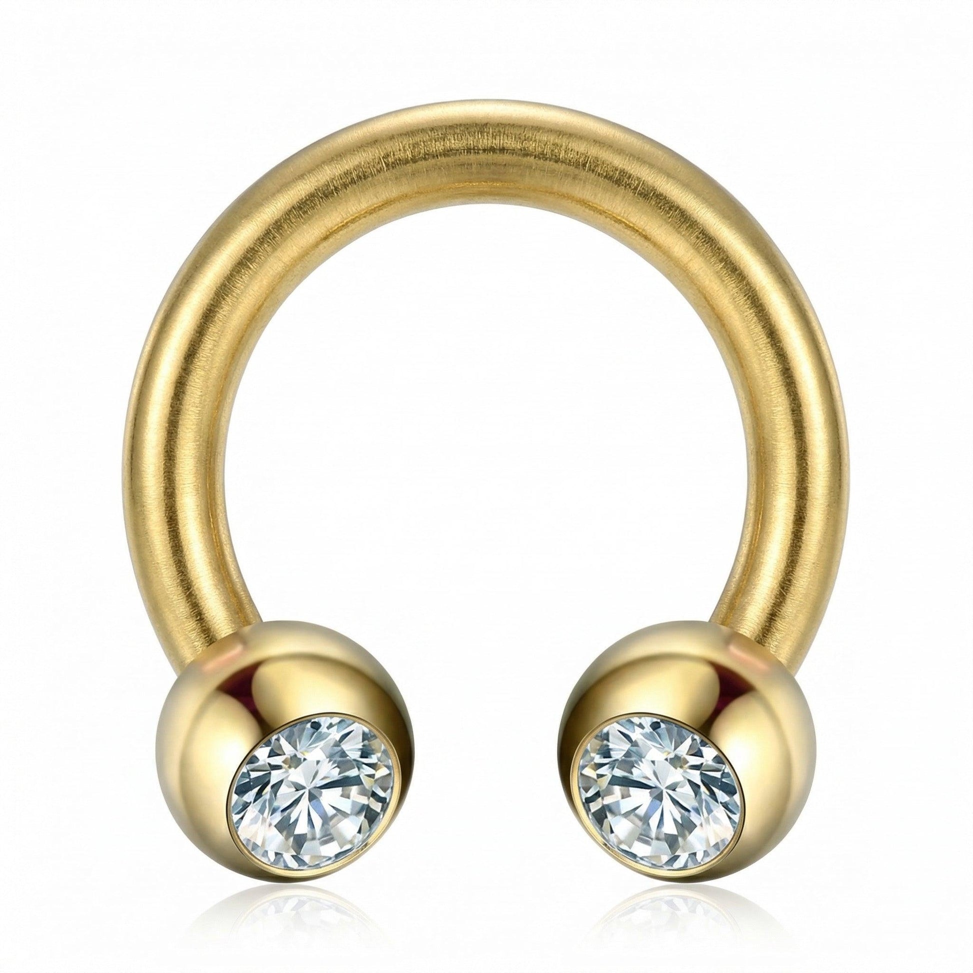 Front-facing close-up of a gold titanium crystal ball horseshoe ring.
