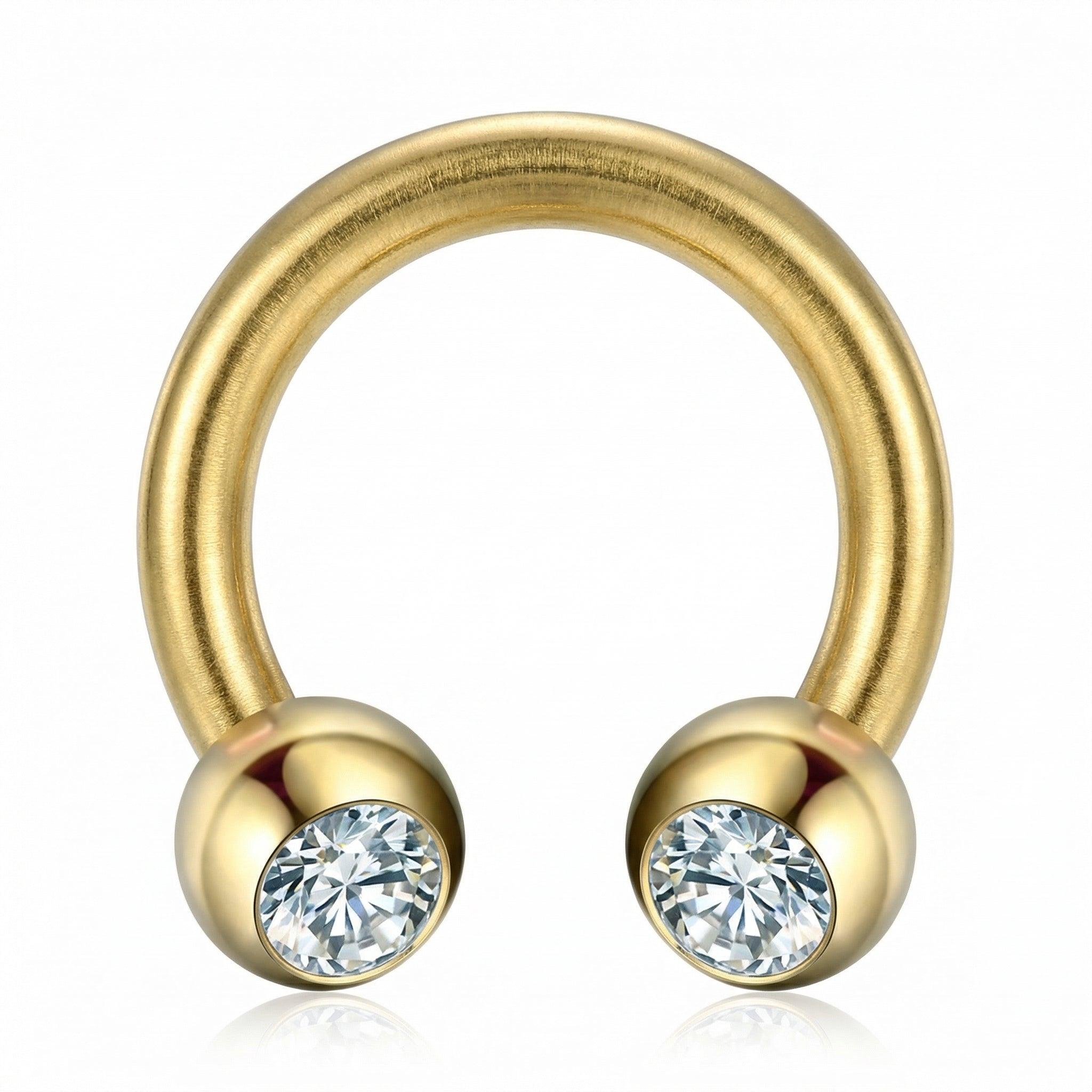 Front-facing close-up of a gold titanium crystal ball horseshoe ring.