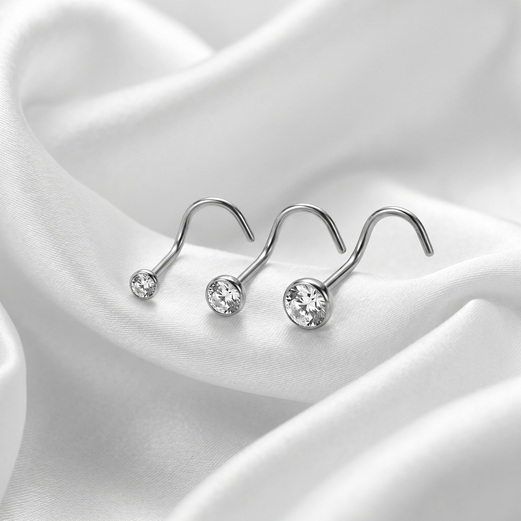 crystal nose stud sizes shown together — G23 titanium 20G