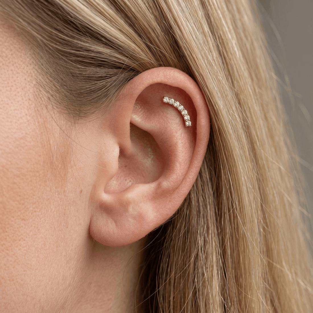 Silver curved bar zircon stud — flat helix piercing placement