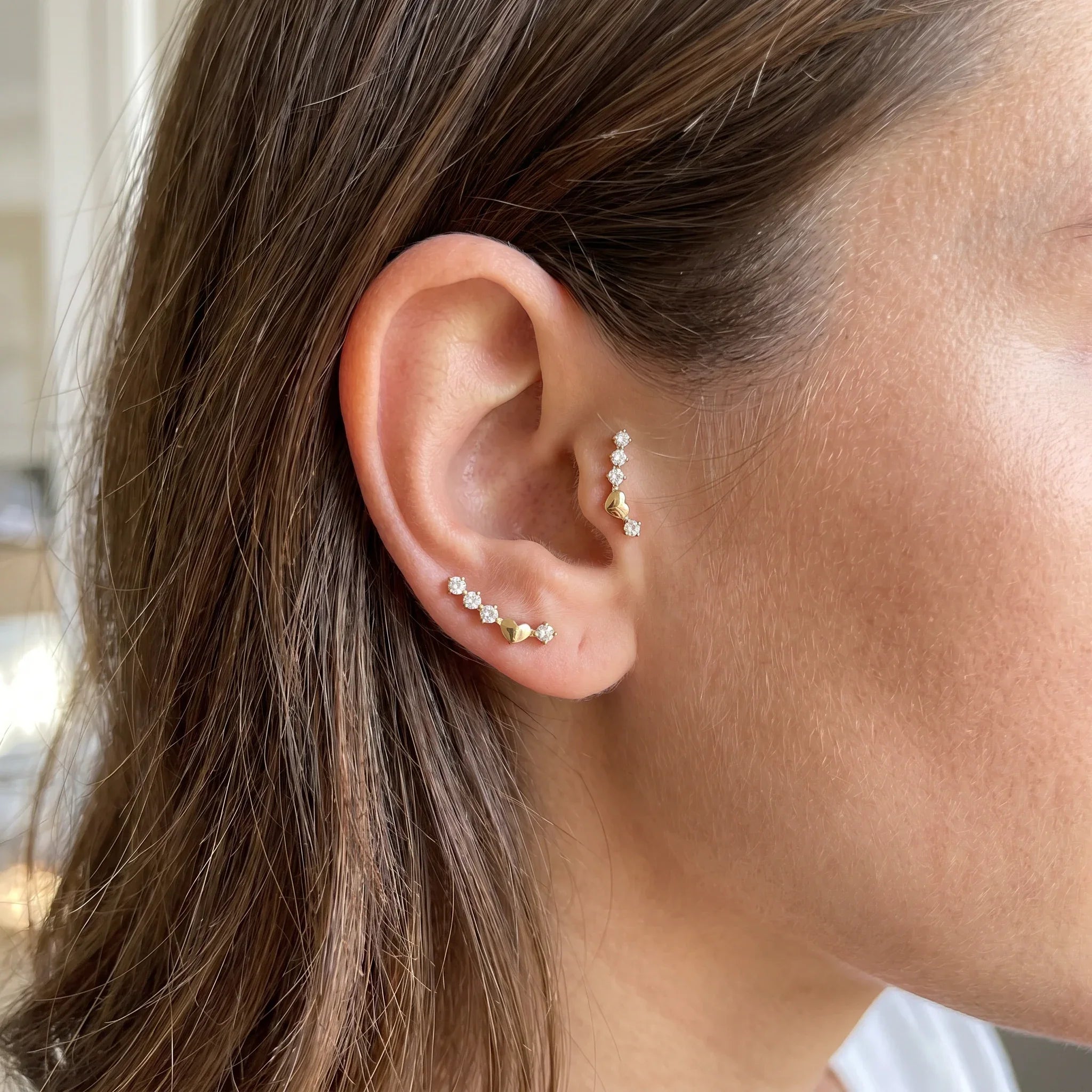 Gold titanium curved zircon piercing stud worn in a female and piercing.