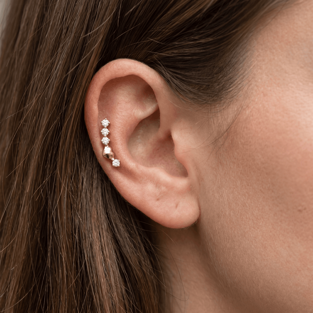 Silver curved zircon stud — mid helix piercing placement