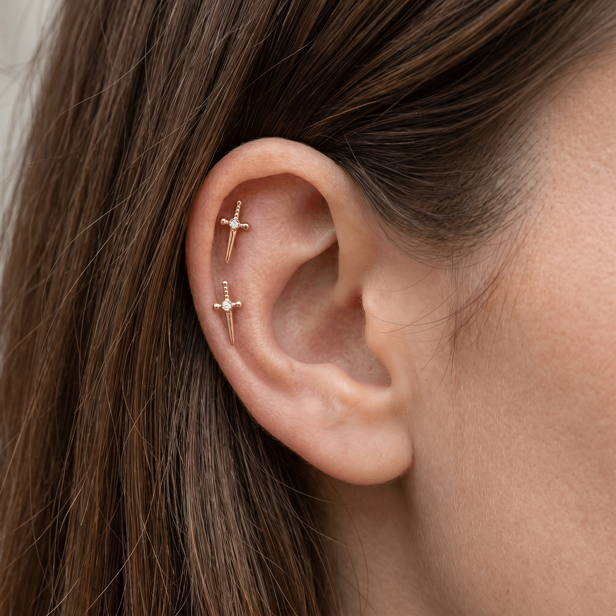 Dagger Front Helix Piercing - Gold dagger stud worn