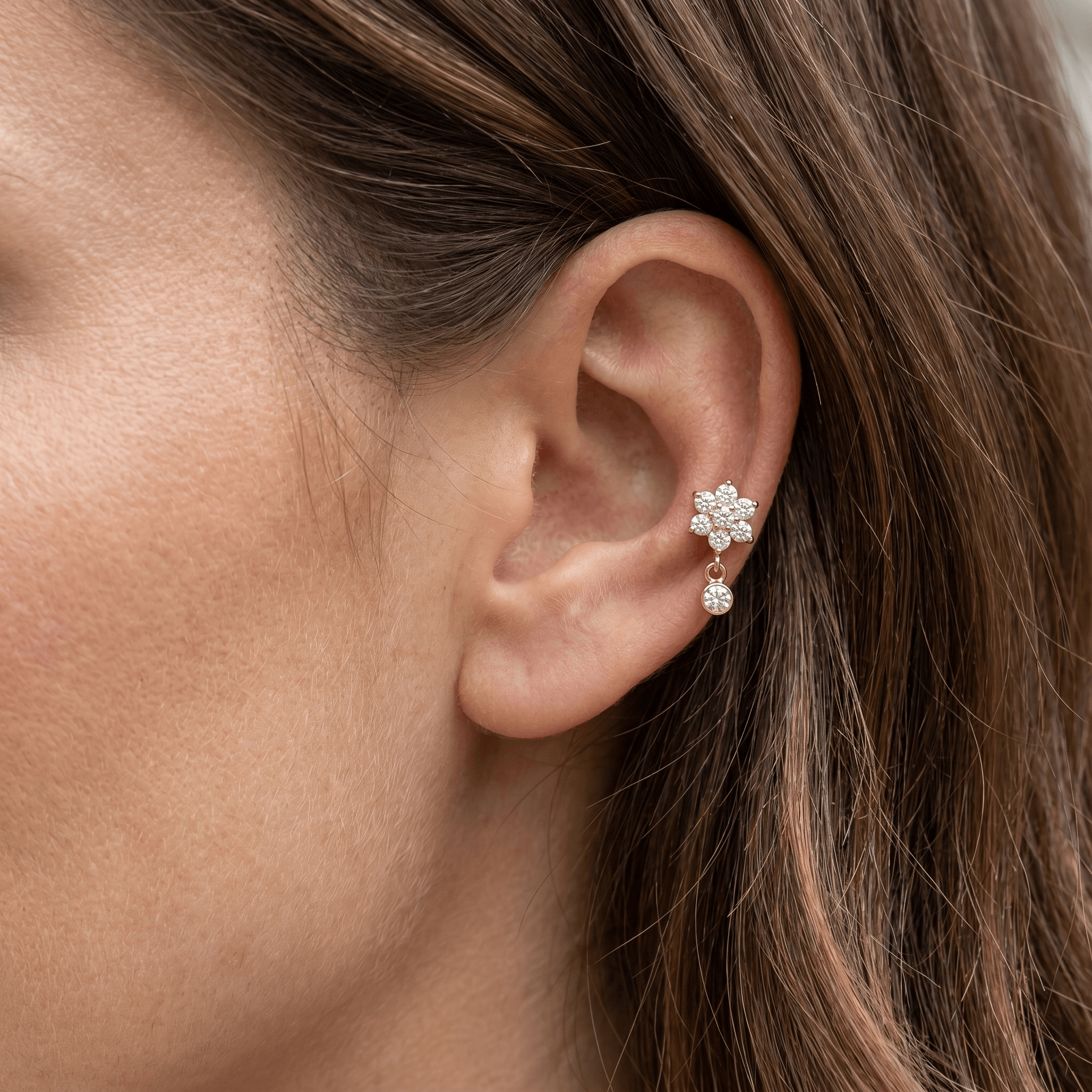 Gold daisy dangle stud — mid helix piercing placement
