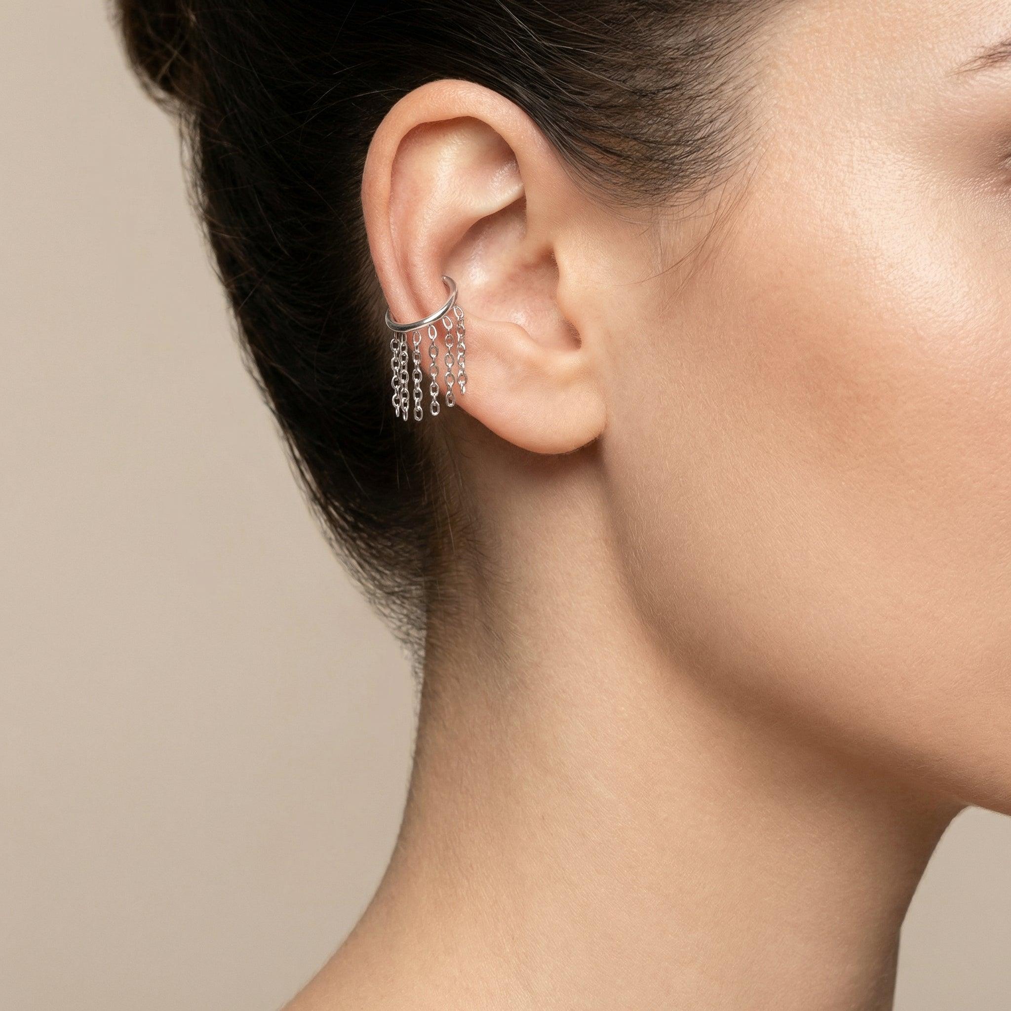 Model showcasing a silver dangling chain clicker ring styled neatly inside the
