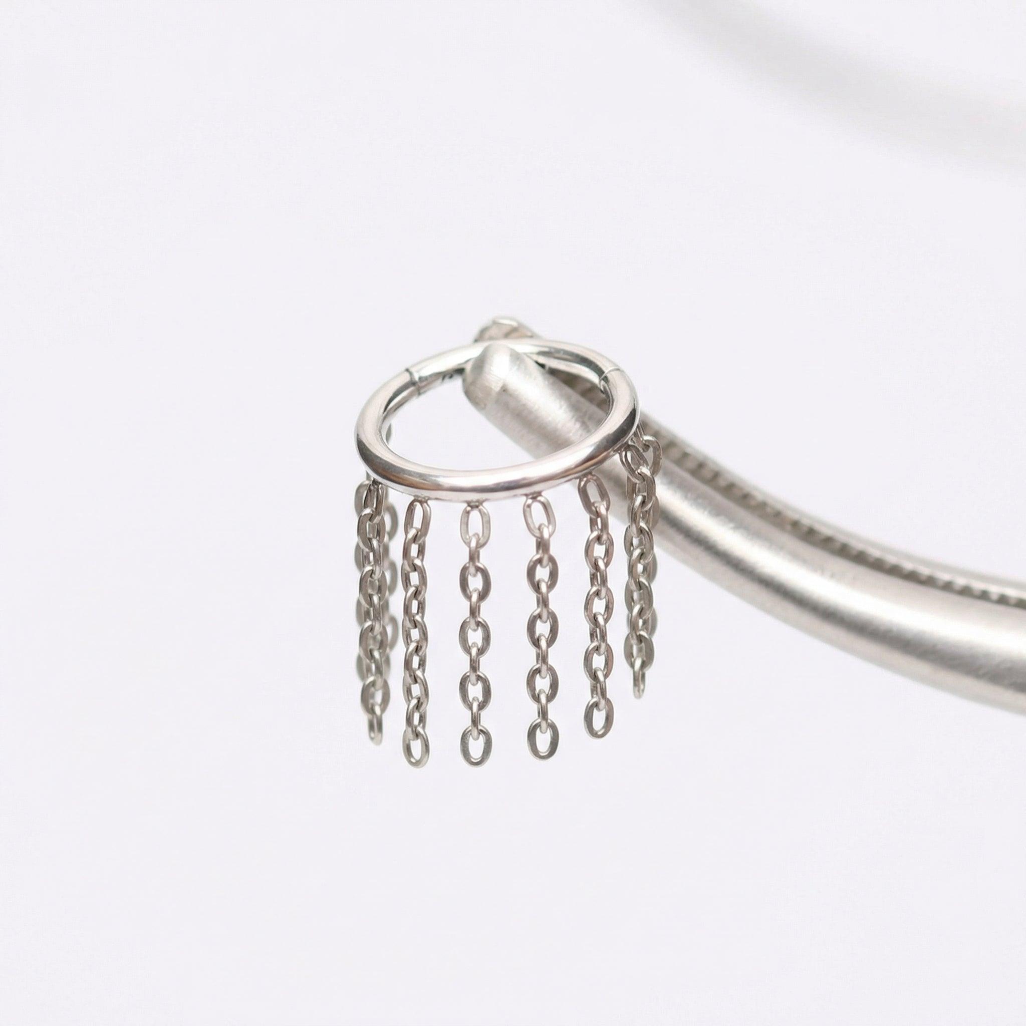Earrings For Cartilage Piercing - Piercing pliers gripping an