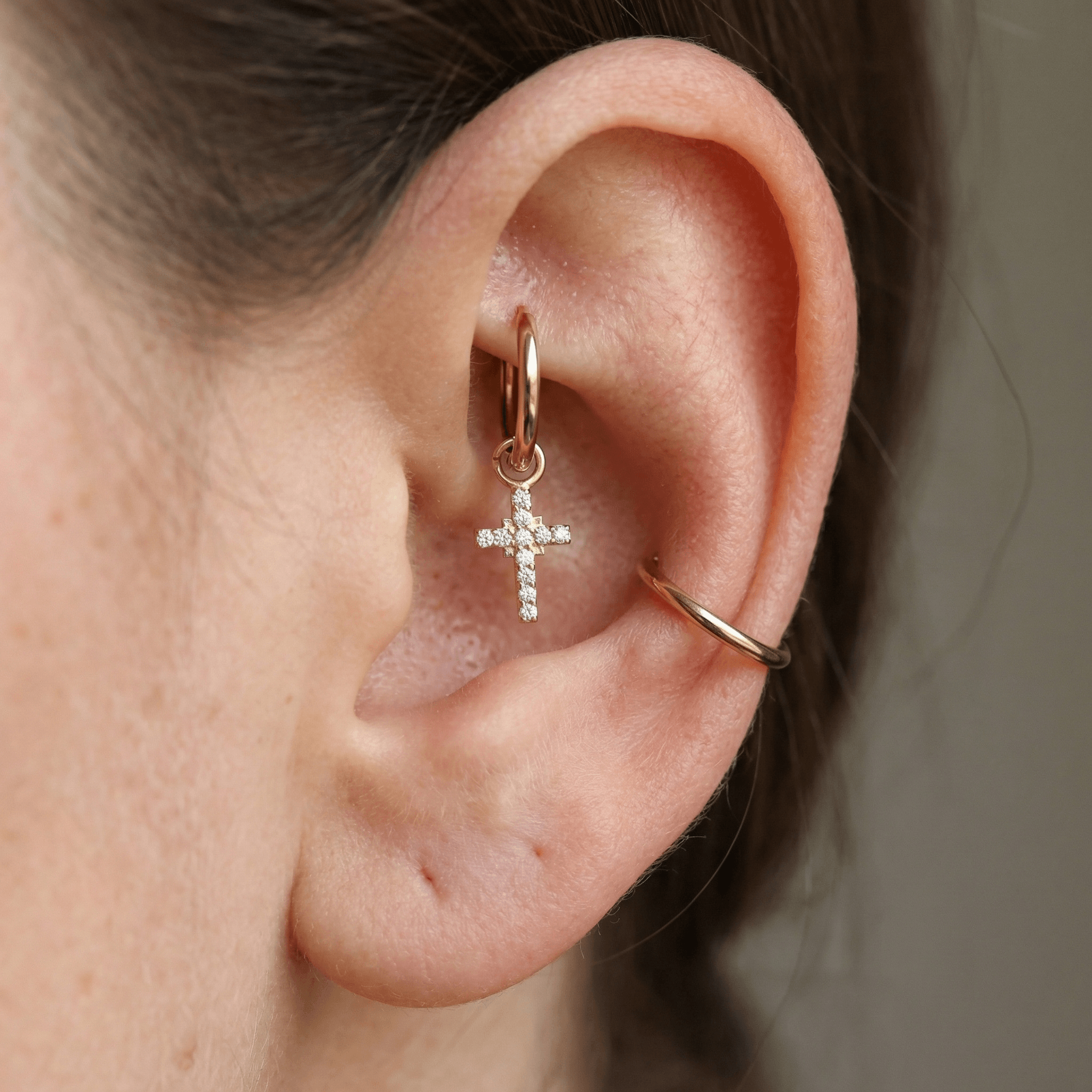 Gold dangling cross zircon stud — rook jewelry placement