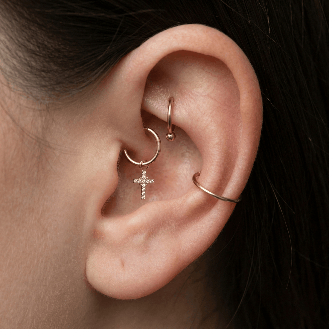 Silver dangling cross zircon stud — daith piercing placement