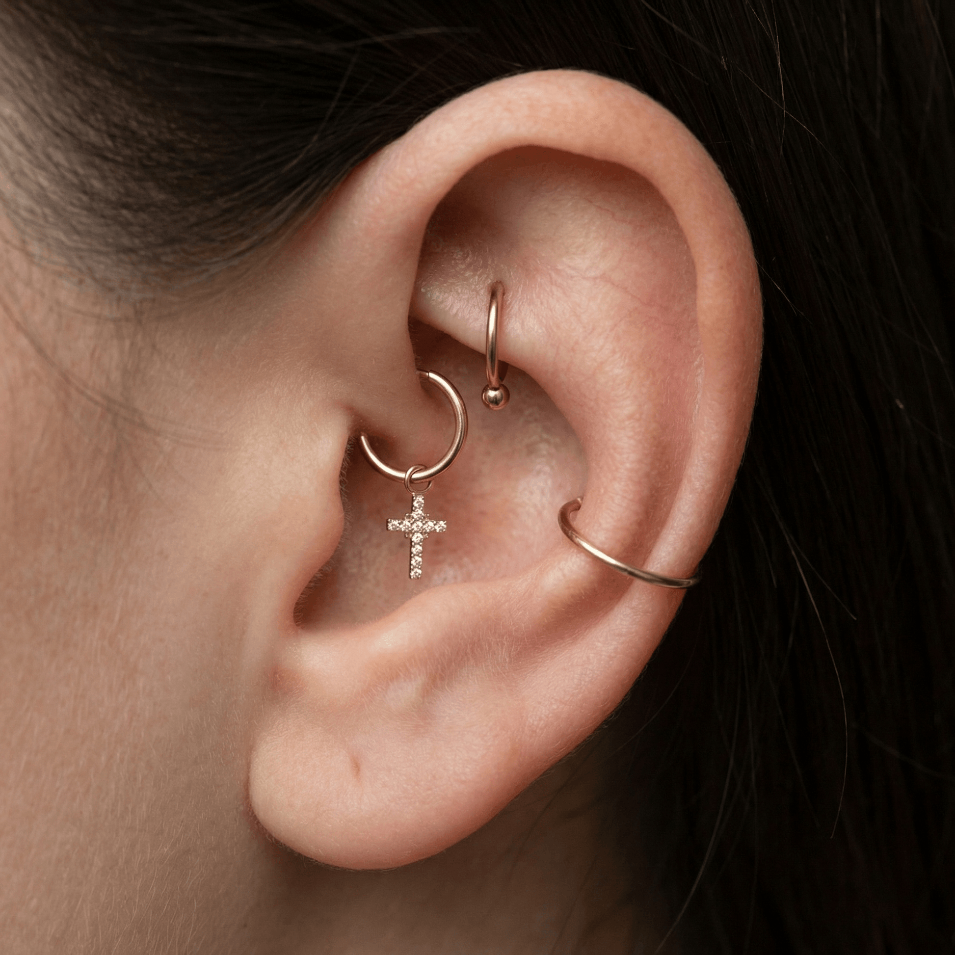 Silver dangling cross zircon stud — daith piercing placement