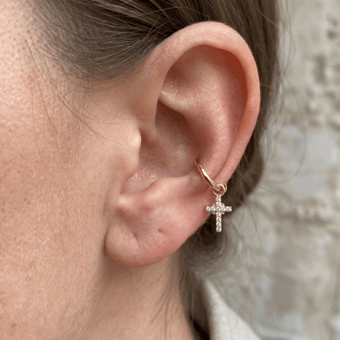 Gold dangling cross zircon stud — mid helix piercing placement
