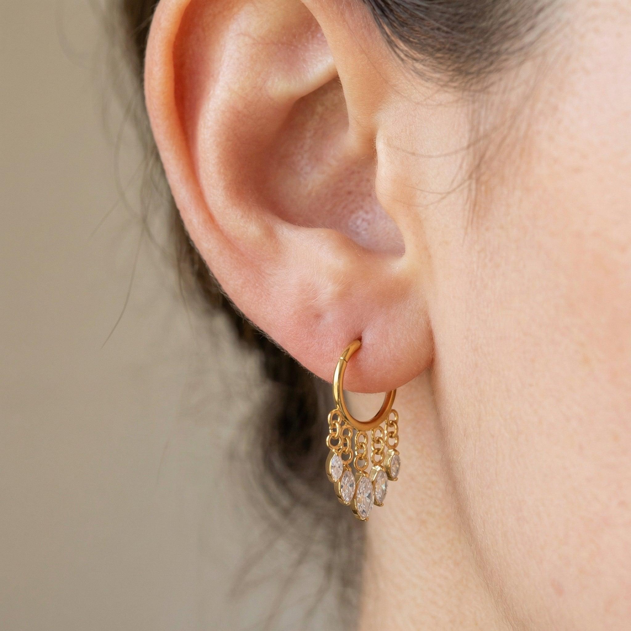 Dangling Piercing In Septum - Model wearing a gold