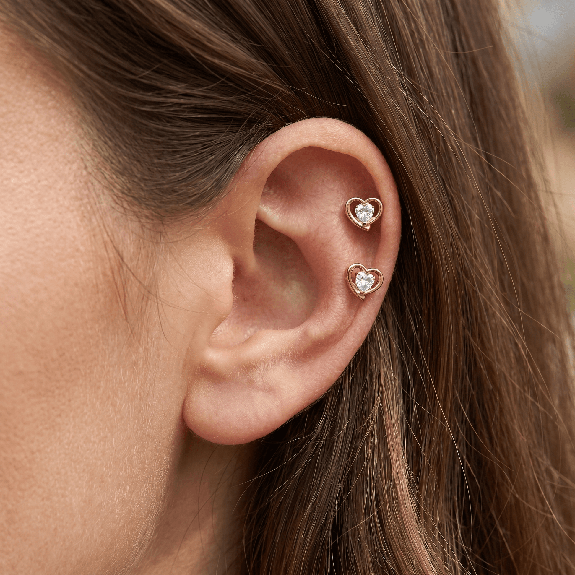 Gold 16g faux piercing worn in a arrangement.