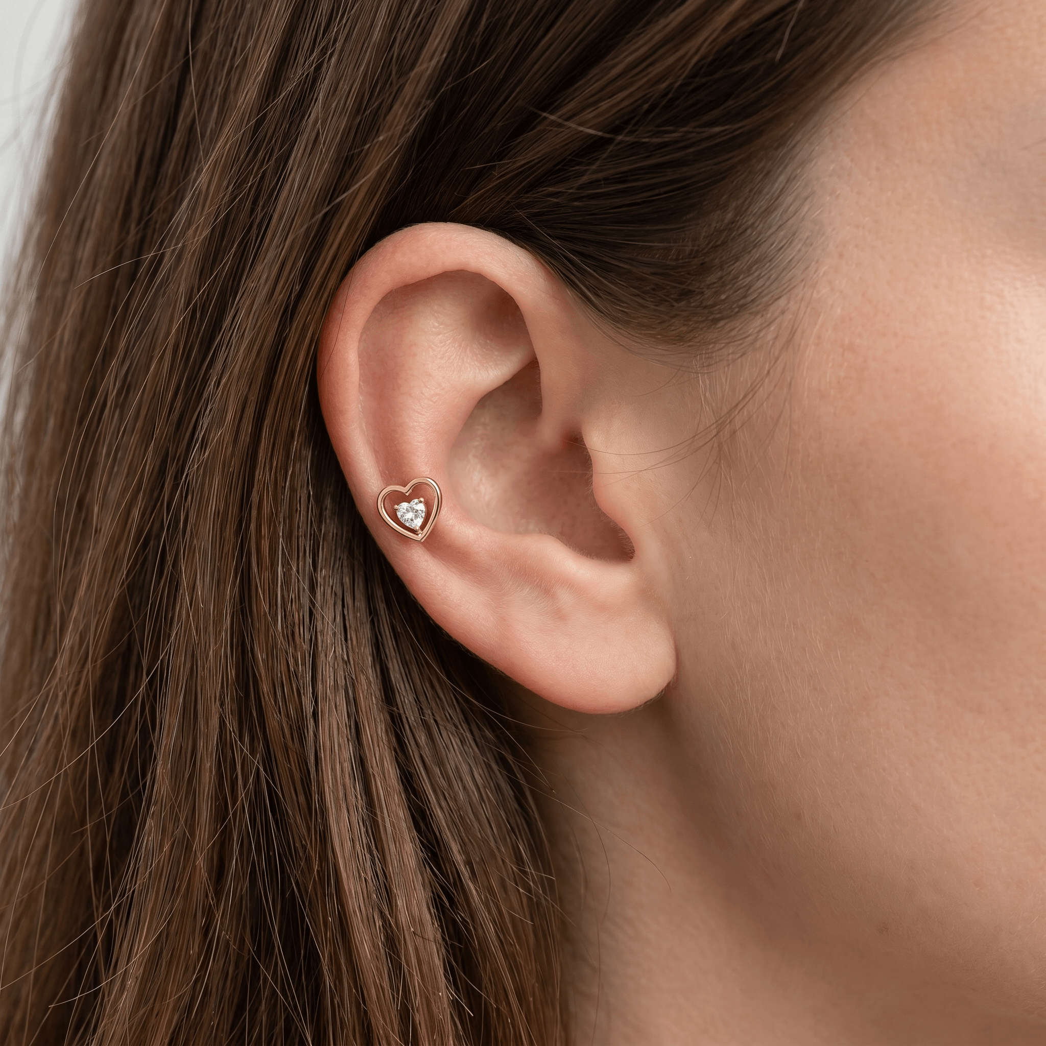 Gold double heart stud worn in a placement.