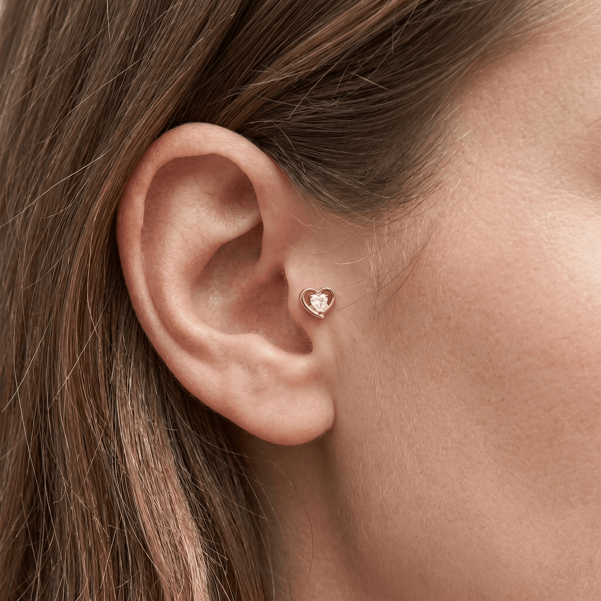 Gold romantic cartilage jewelry worn gracefully in a piercing.