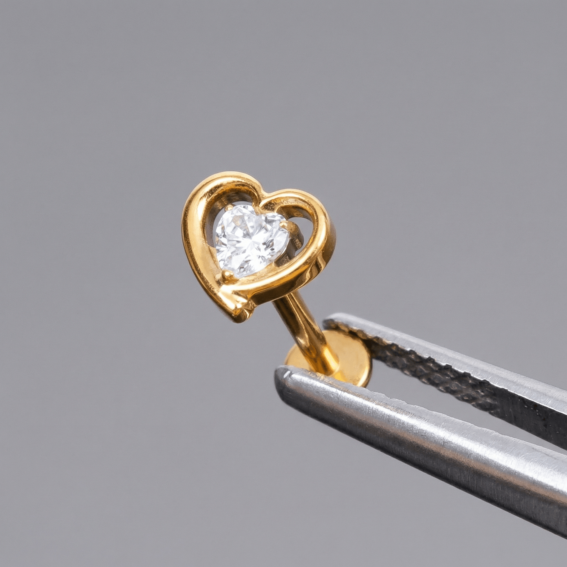 Gold double heart zircon stud — piercing placement