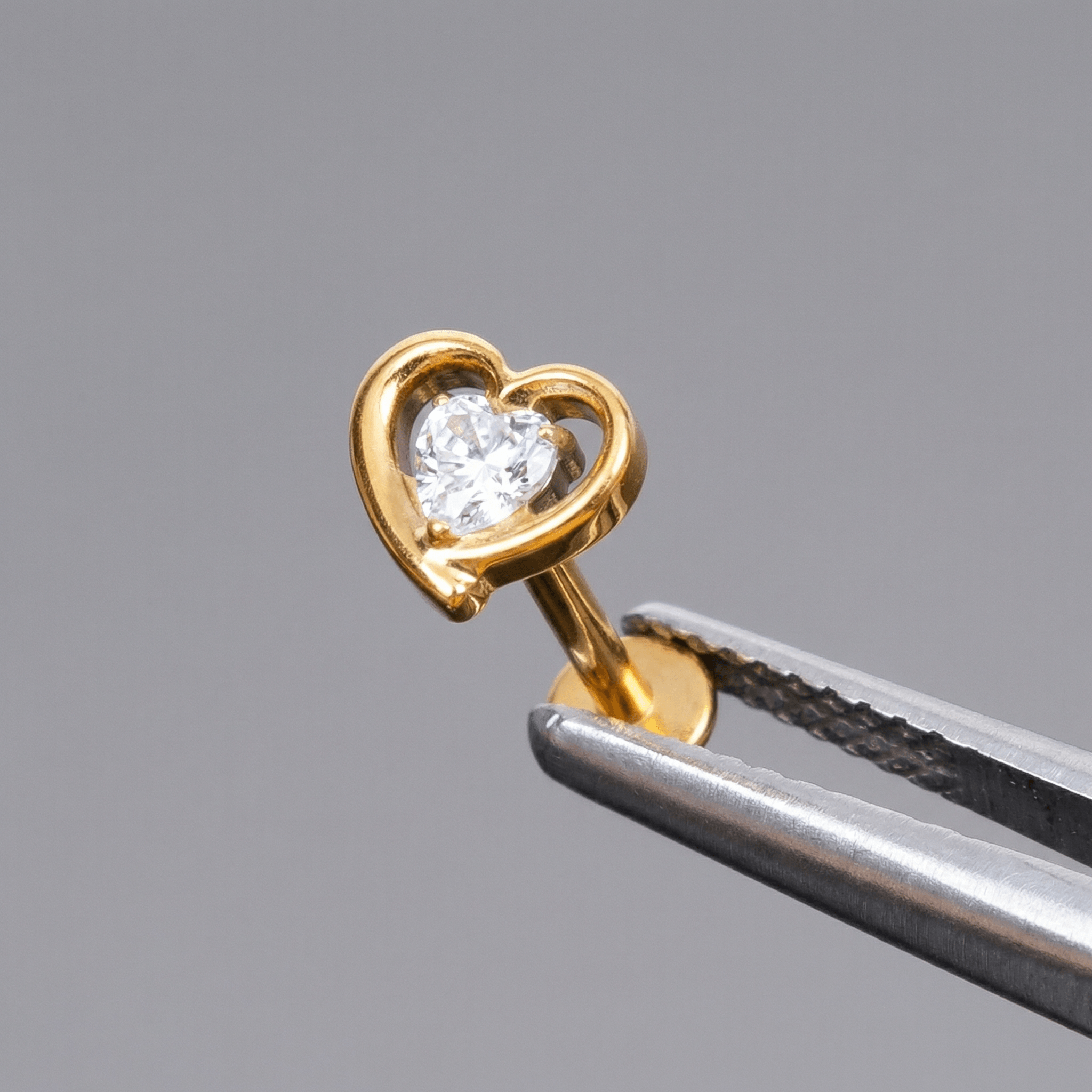 Gold double heart zircon stud — piercing placement