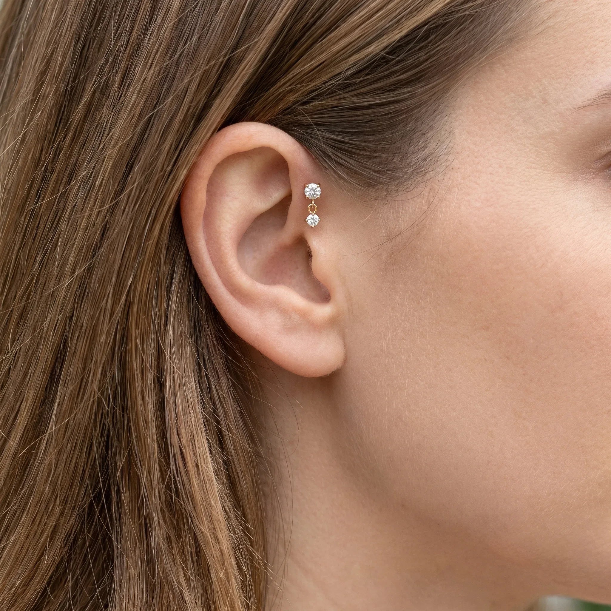 Silver double zircon stud styled in a piercing.