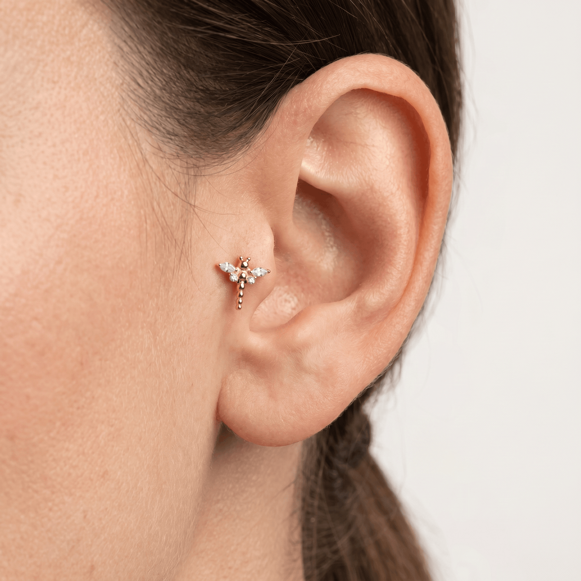Gold dragonfly styled perfectly in a piercing