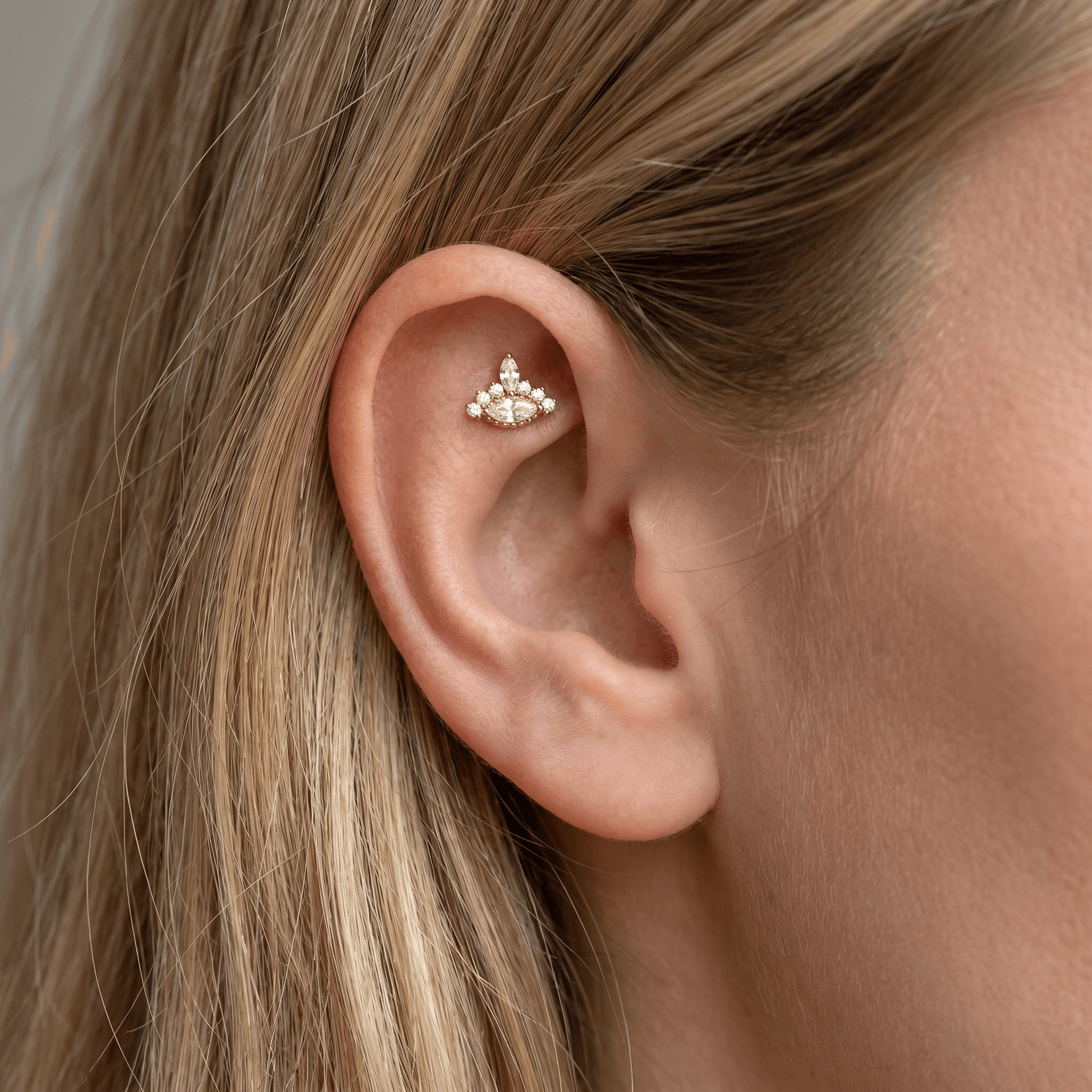 Gold protective symbol styled perfectly in an faux piercing.