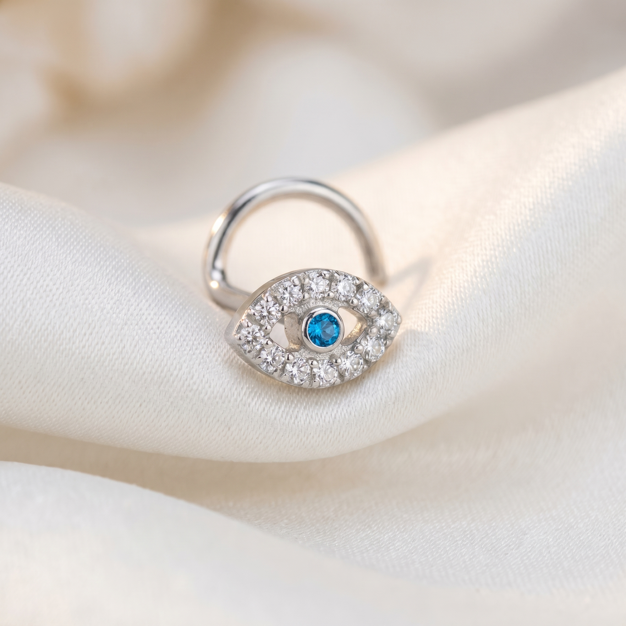 evil eye nose stud worn on a model — hypoallergenic titanium