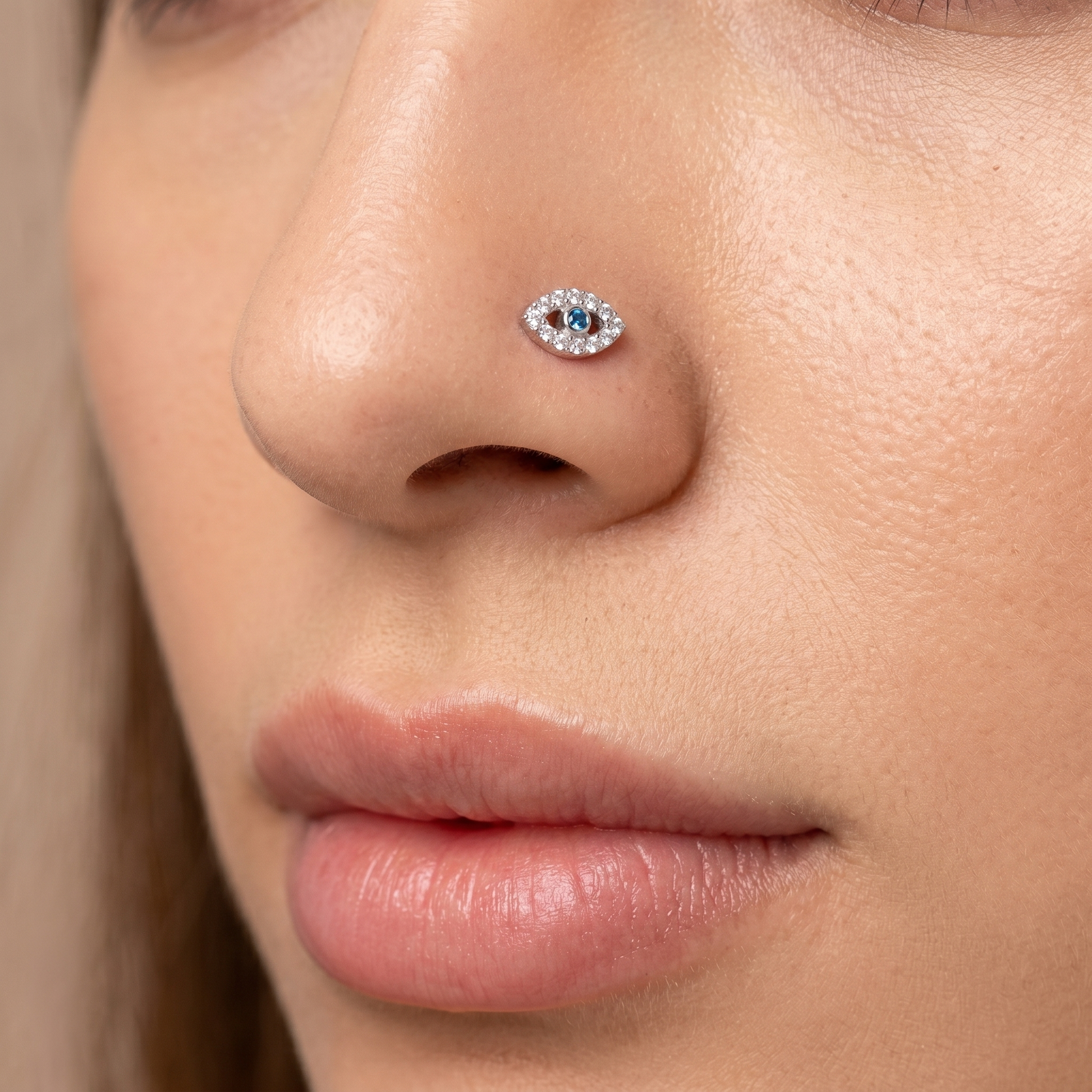 evil eye nose stud worn on a model, side profile