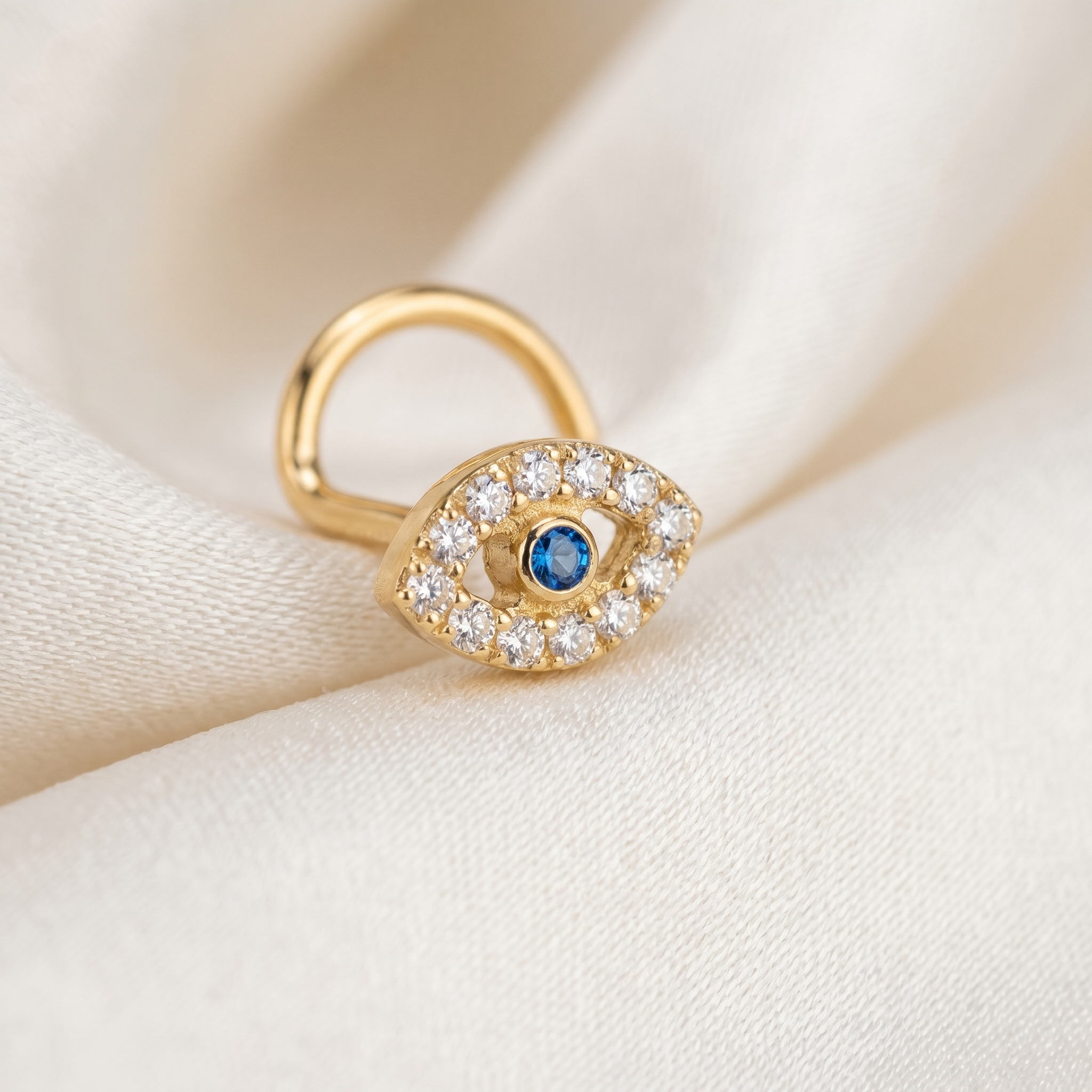 evil eye nose stud on satin fabric — G23 titanium 20G
