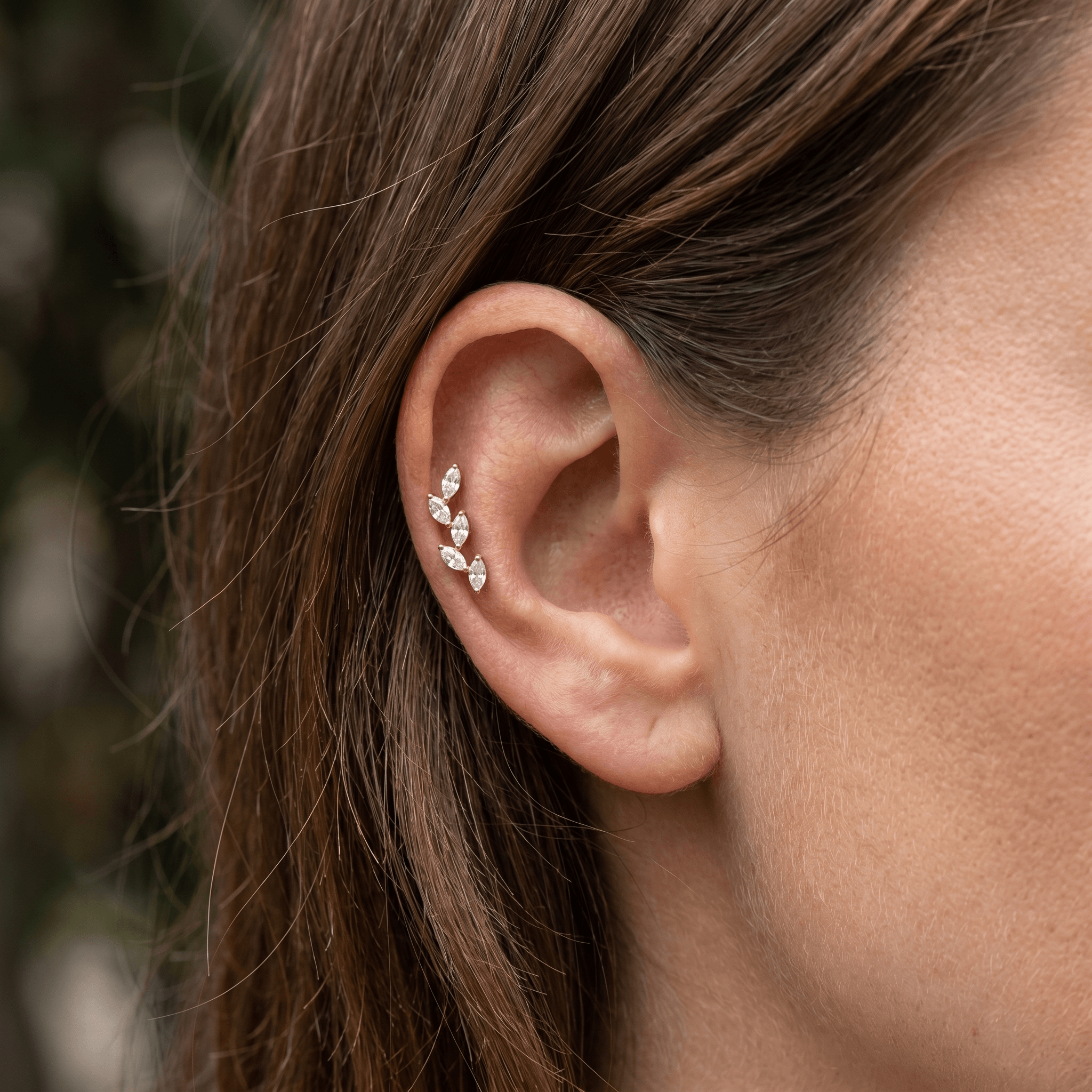 Gold five stone styled perfectly in a piercing.