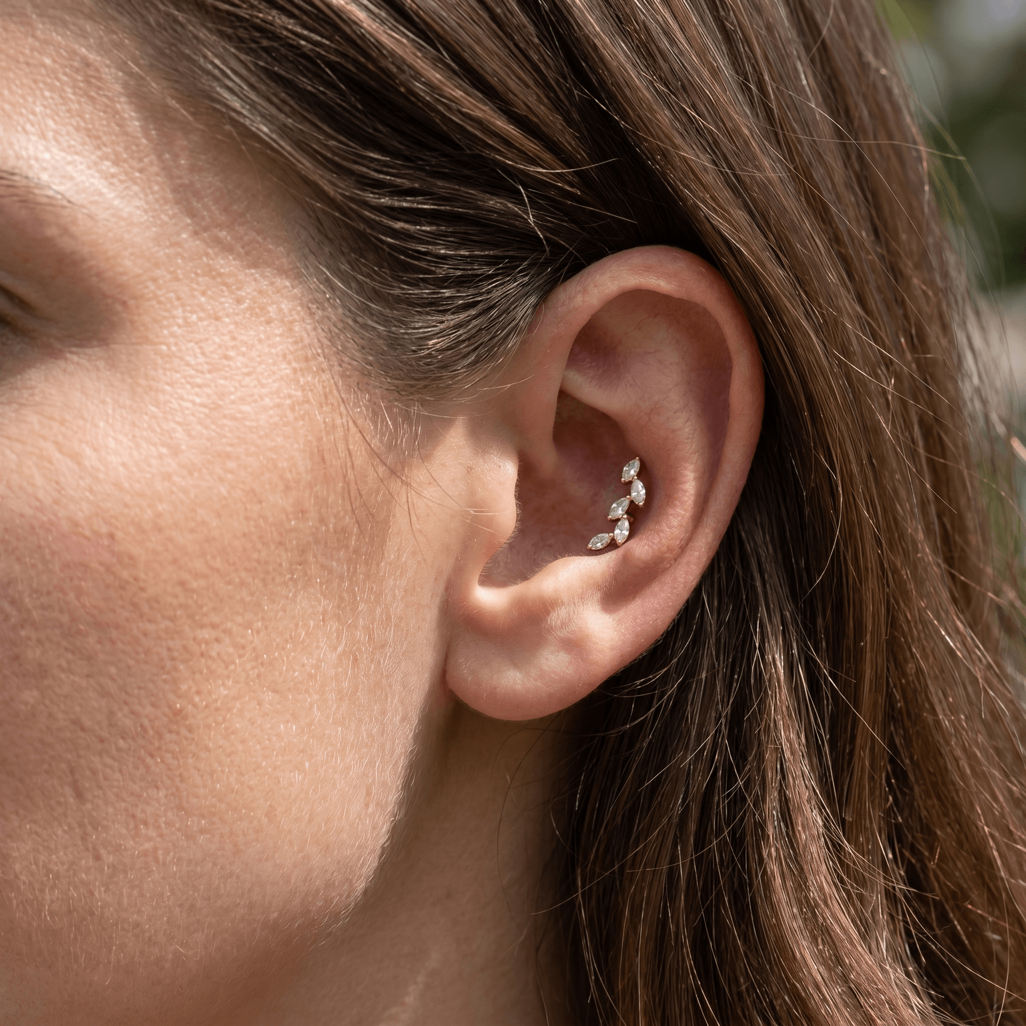 Silver marquise zircon stud worn gracefully in a conch ear piercing.