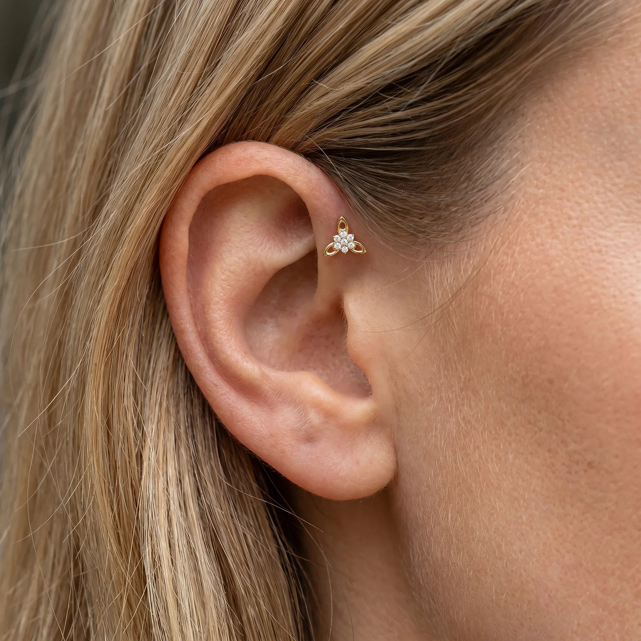 Gold titanium CZ flower cluster piercing stud worn perfectly in a female